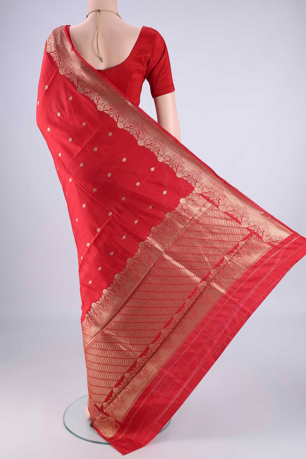 Flat view of Red Banarasi Katan Silk Saree with Zari Butta on the body and Zari Border. 