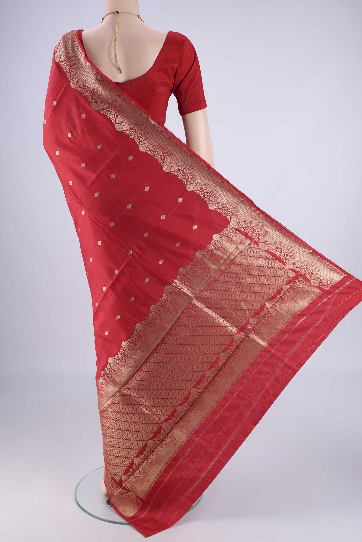 Flat view of Red Banarasi Katan Silk Saree with Zari Butta on the body and Zari Border. 