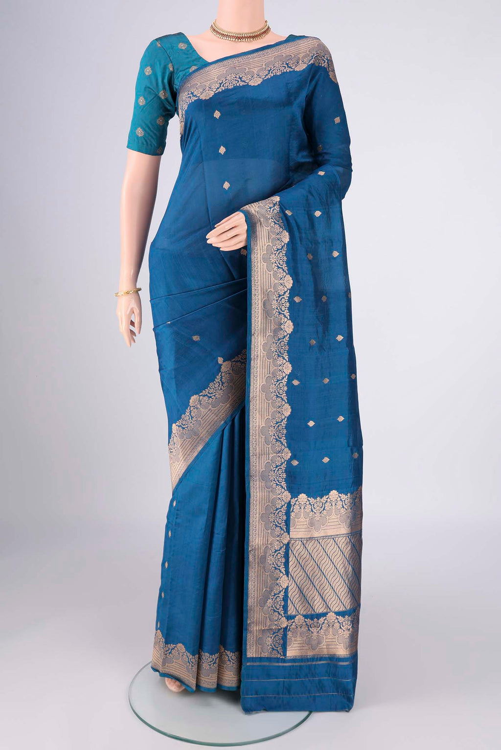 Blue Banarasi Katan Silk Saree with Zari Butta on the body and Zari Border.  displayed on a mannequin