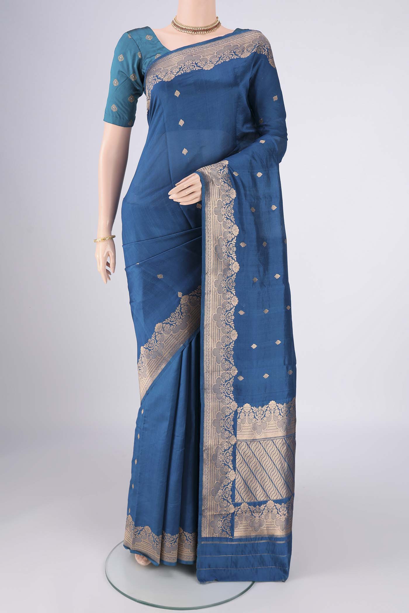 Blue Banarasi Katan Silk Saree with Zari Butta on the body and Zari Border.  displayed on a mannequin