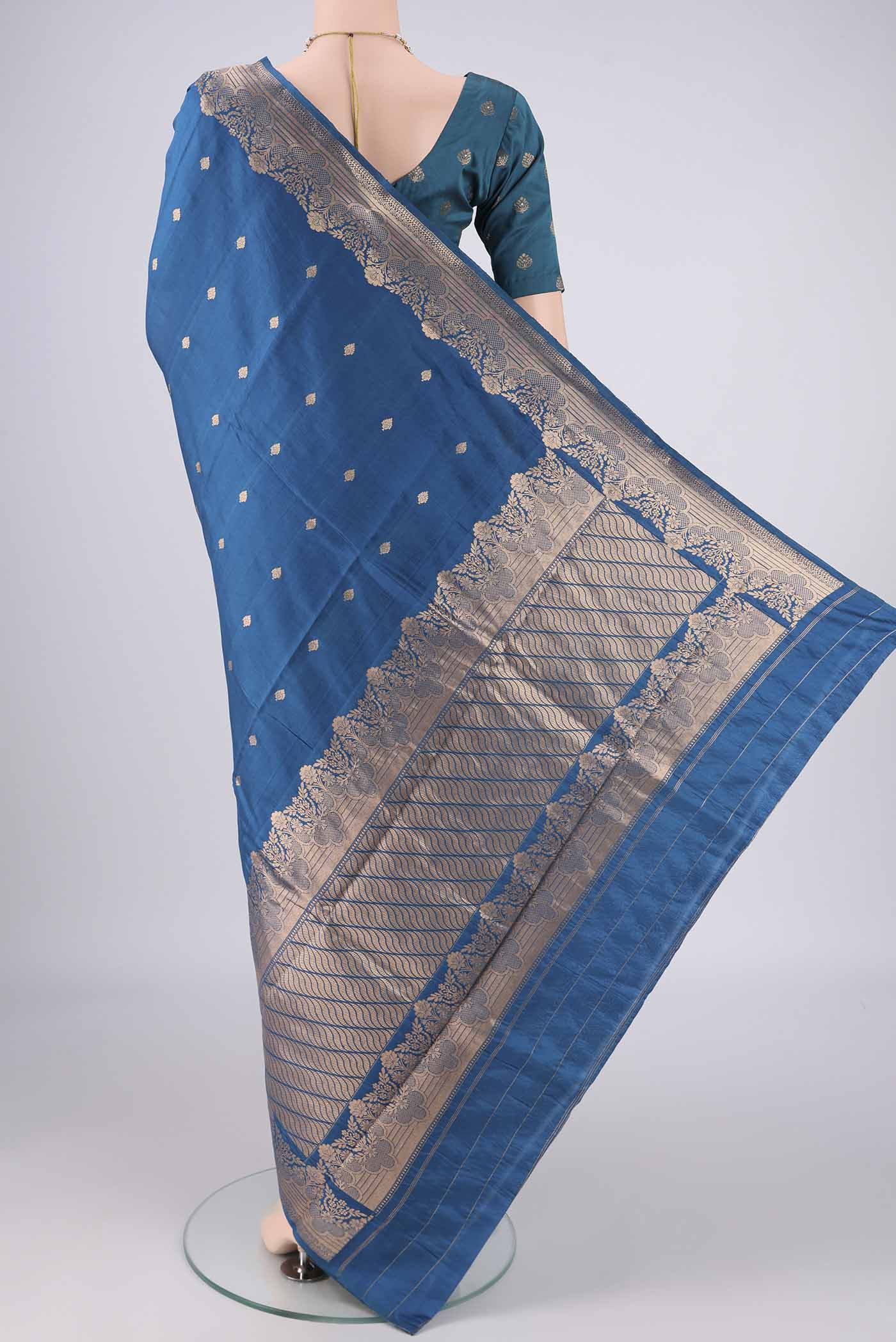 Flat view of Blue Banarasi Katan Silk Saree with Zari Butta on the body and Zari Border. 