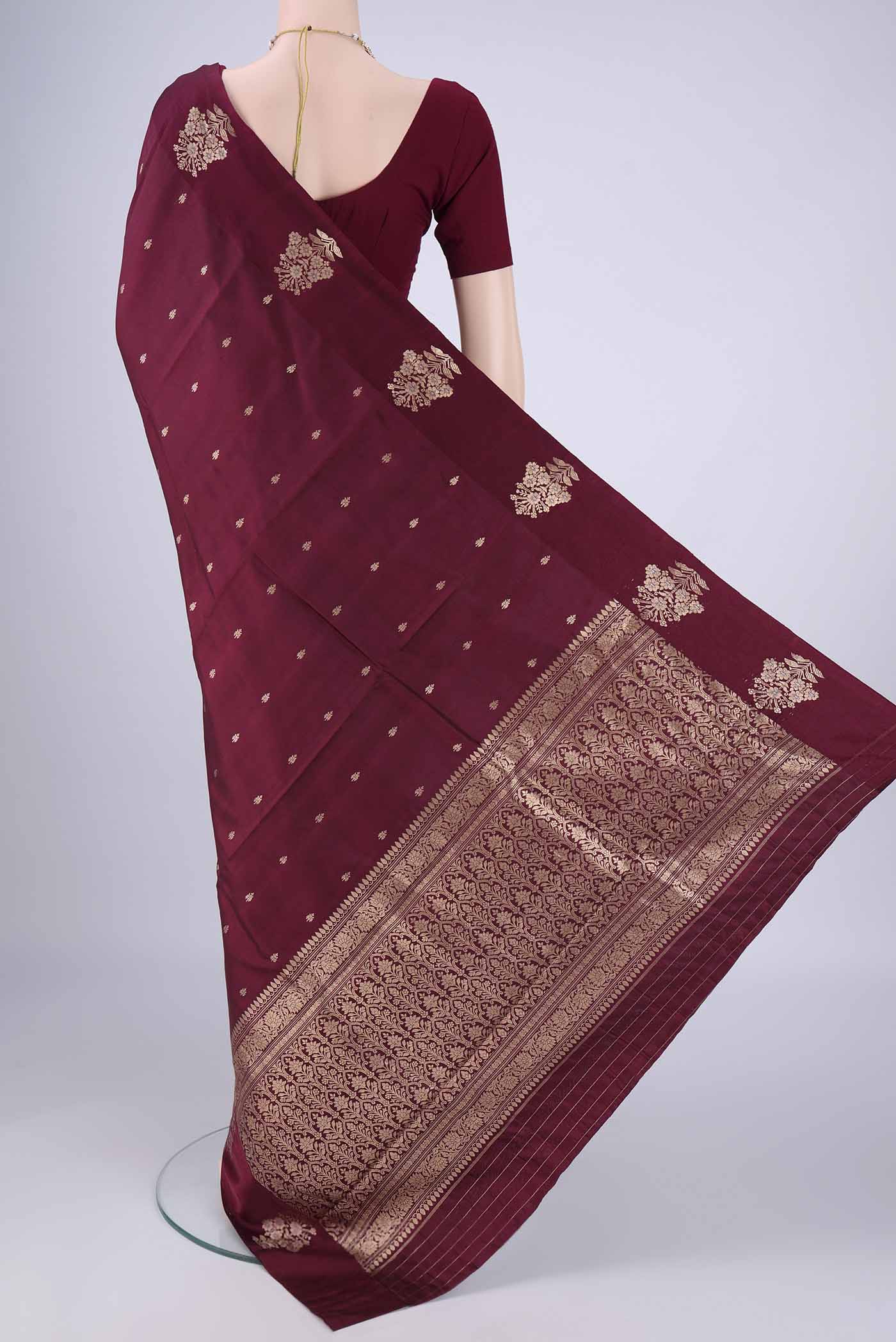 Flat view of Maroon Banarasi Katan Silk Saree with Zari Butta on the body and Satin Border. 