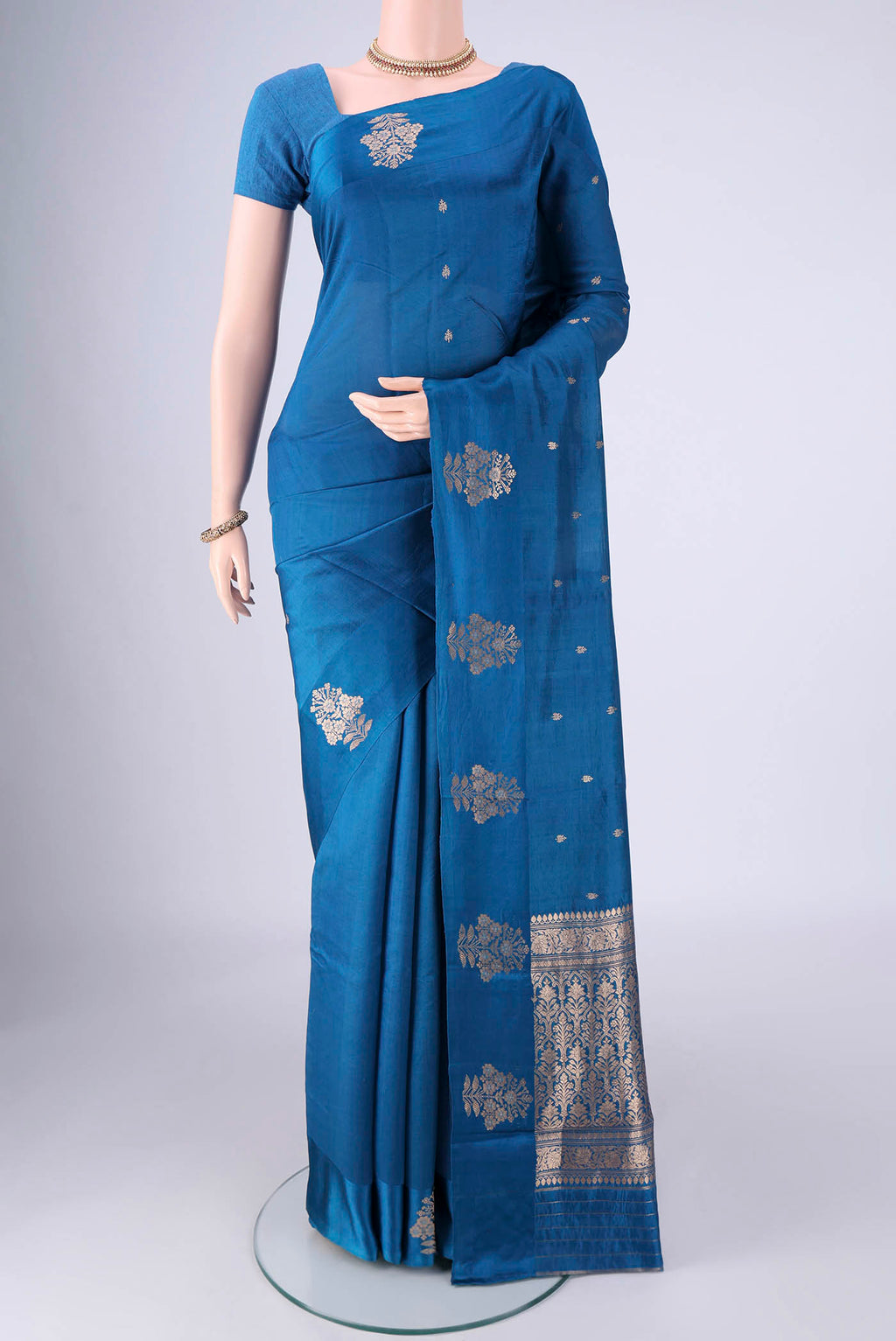 Blue Banarasi Katan Silk Saree with Zari Butta on the body and Satin Border.  displayed on a mannequin