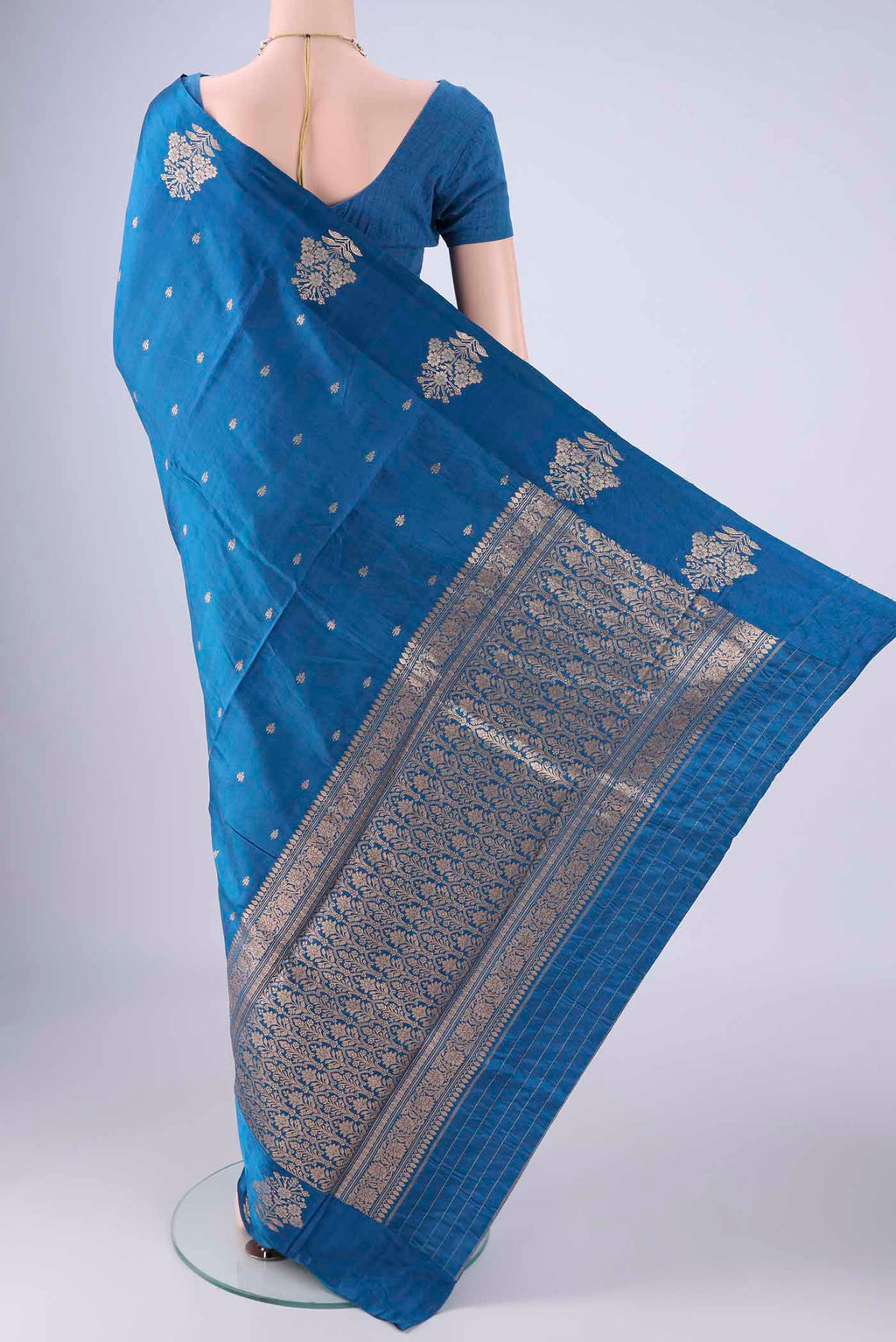 Flat view of Blue Banarasi Katan Silk Saree with Zari Butta on the body and Satin Border. 