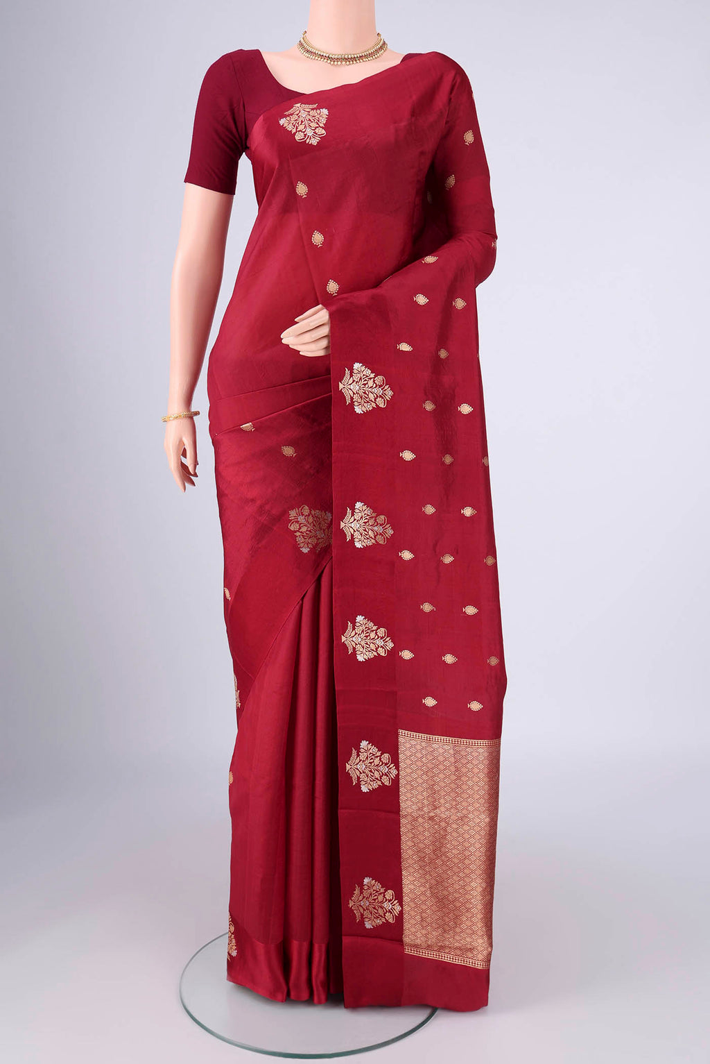 Maroon Banarasi Katan Silk Saree with Zari Butta on the body and Satin Border.  displayed on a mannequin