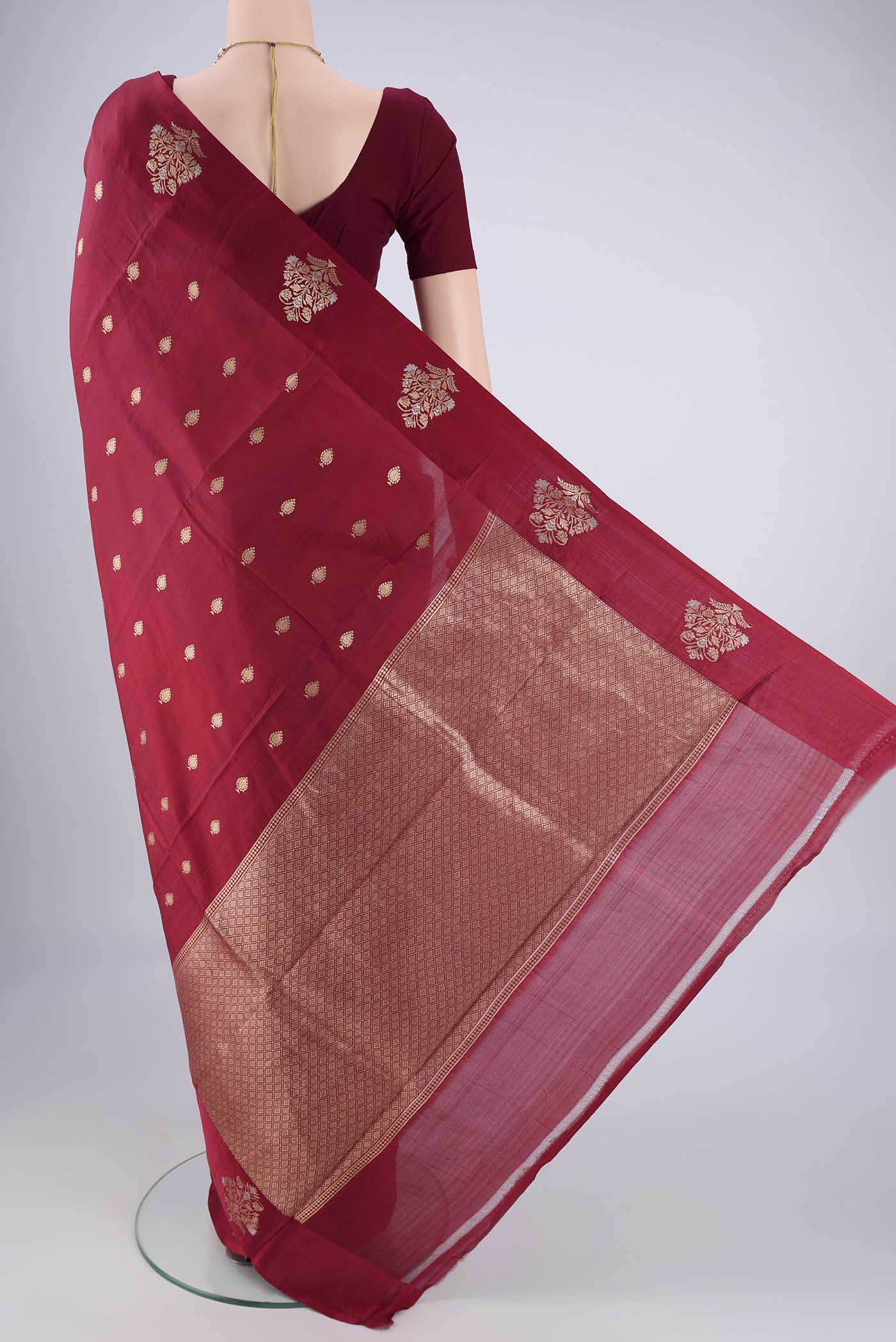 Flat view of Maroon Banarasi Katan Silk Saree with Zari Butta on the body and Satin Border. 