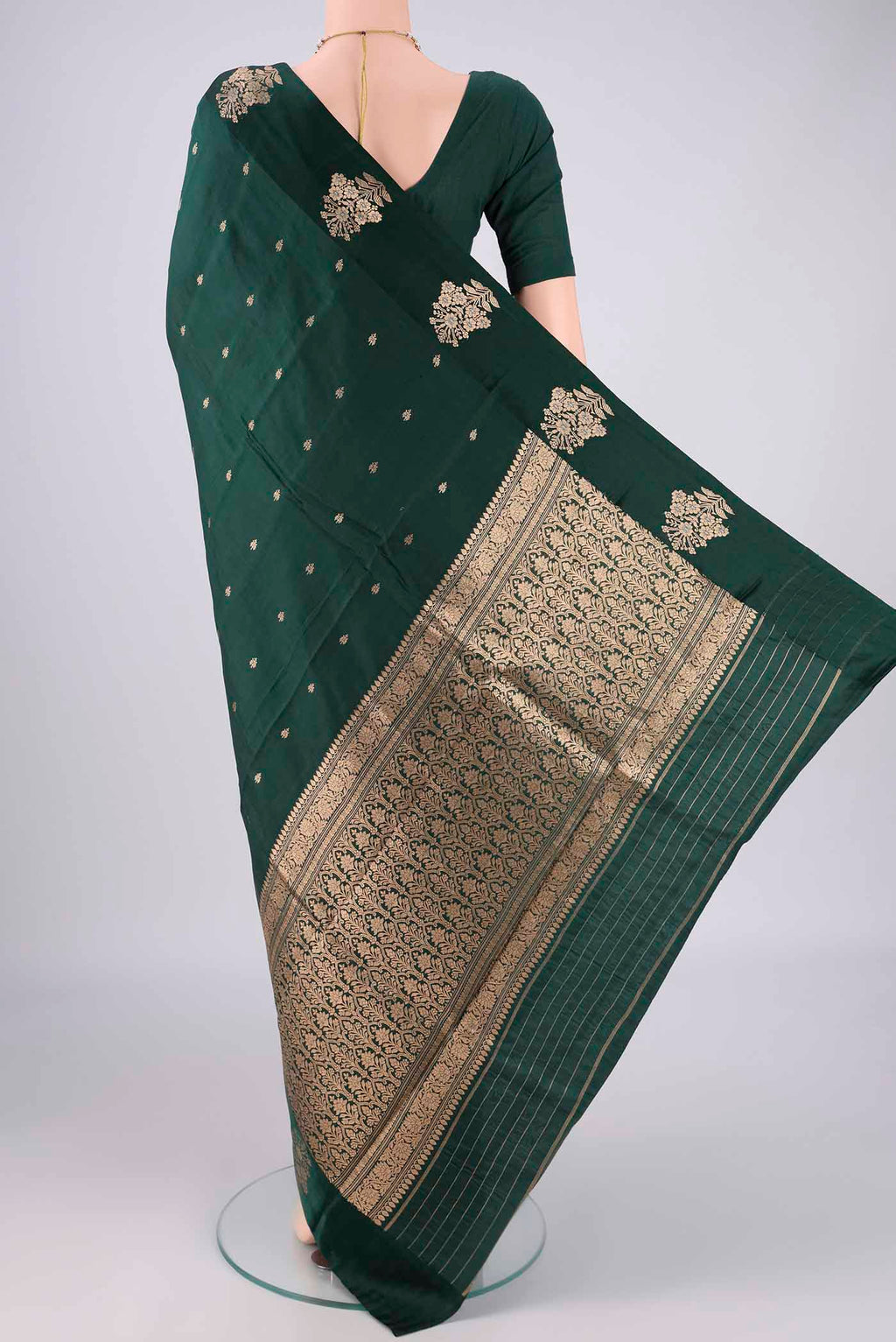 Flat view of Bottle Green Banarasi Katan Silk Saree with Zari Butta on the body and Plain Border. 