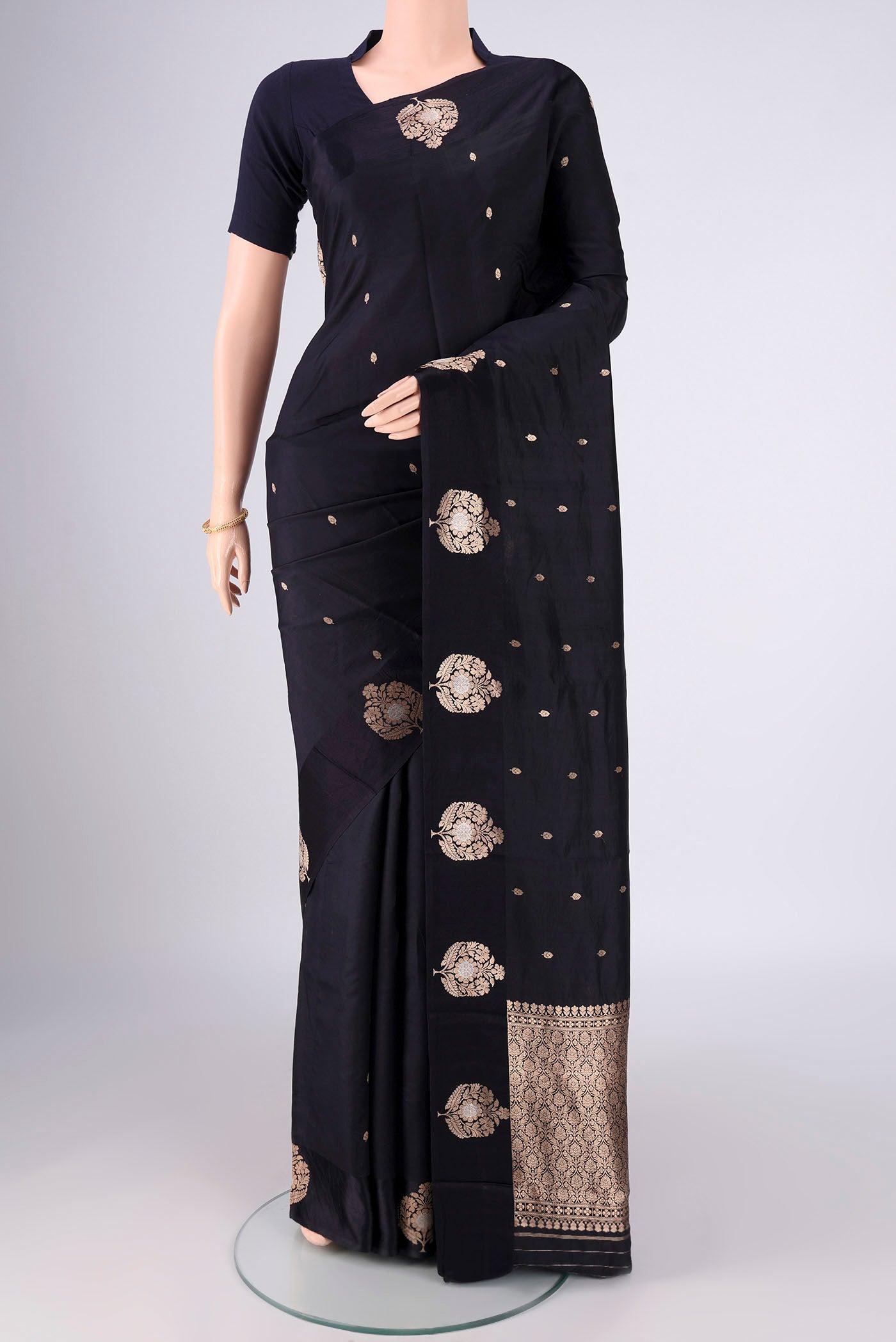 Black Banarasi Katan Silk Saree with Zari Butta on the body and Plain Border.  displayed on a mannequin