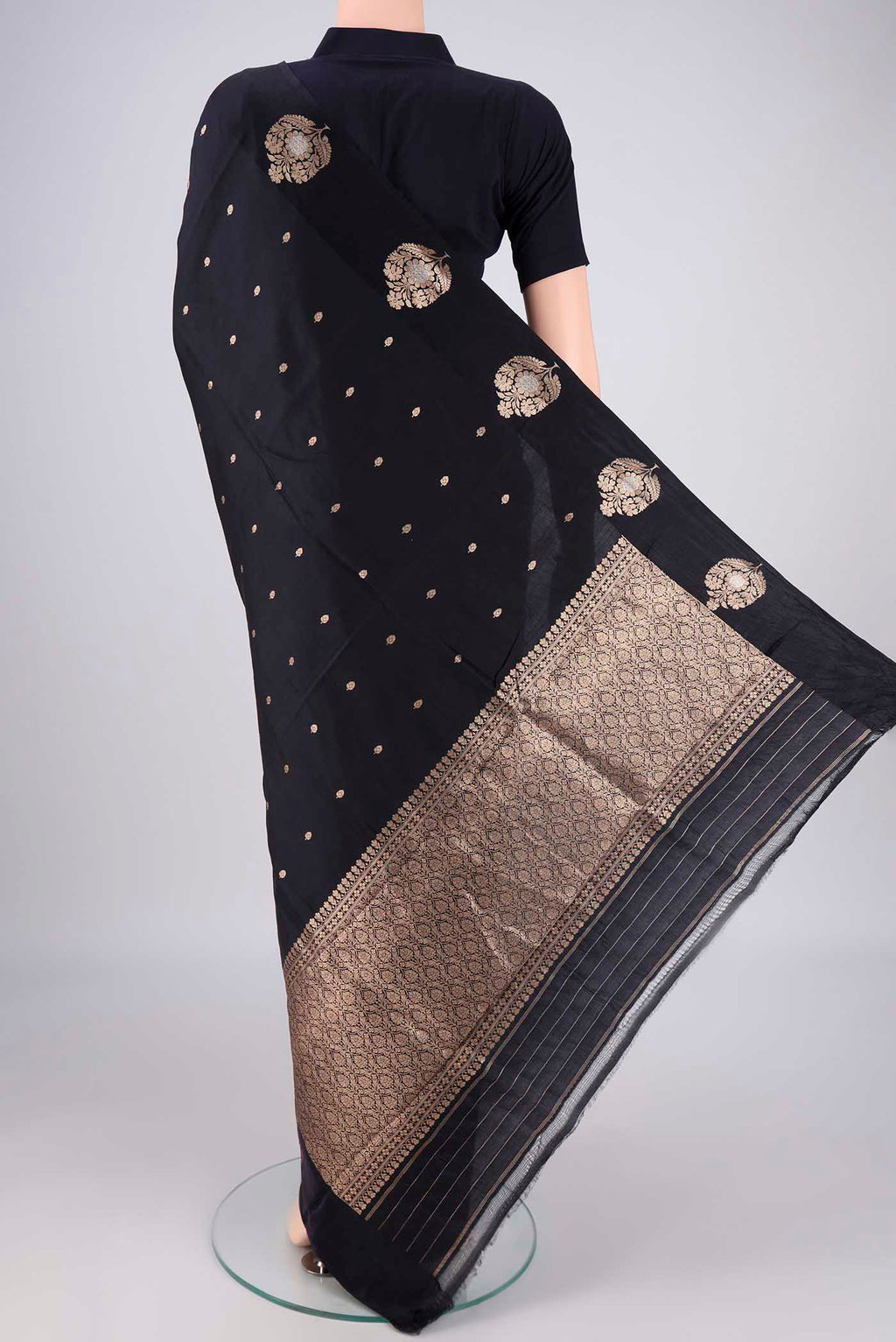Flat view of Black Banarasi Katan Silk Saree with Zari Butta on the body and Plain Border. 