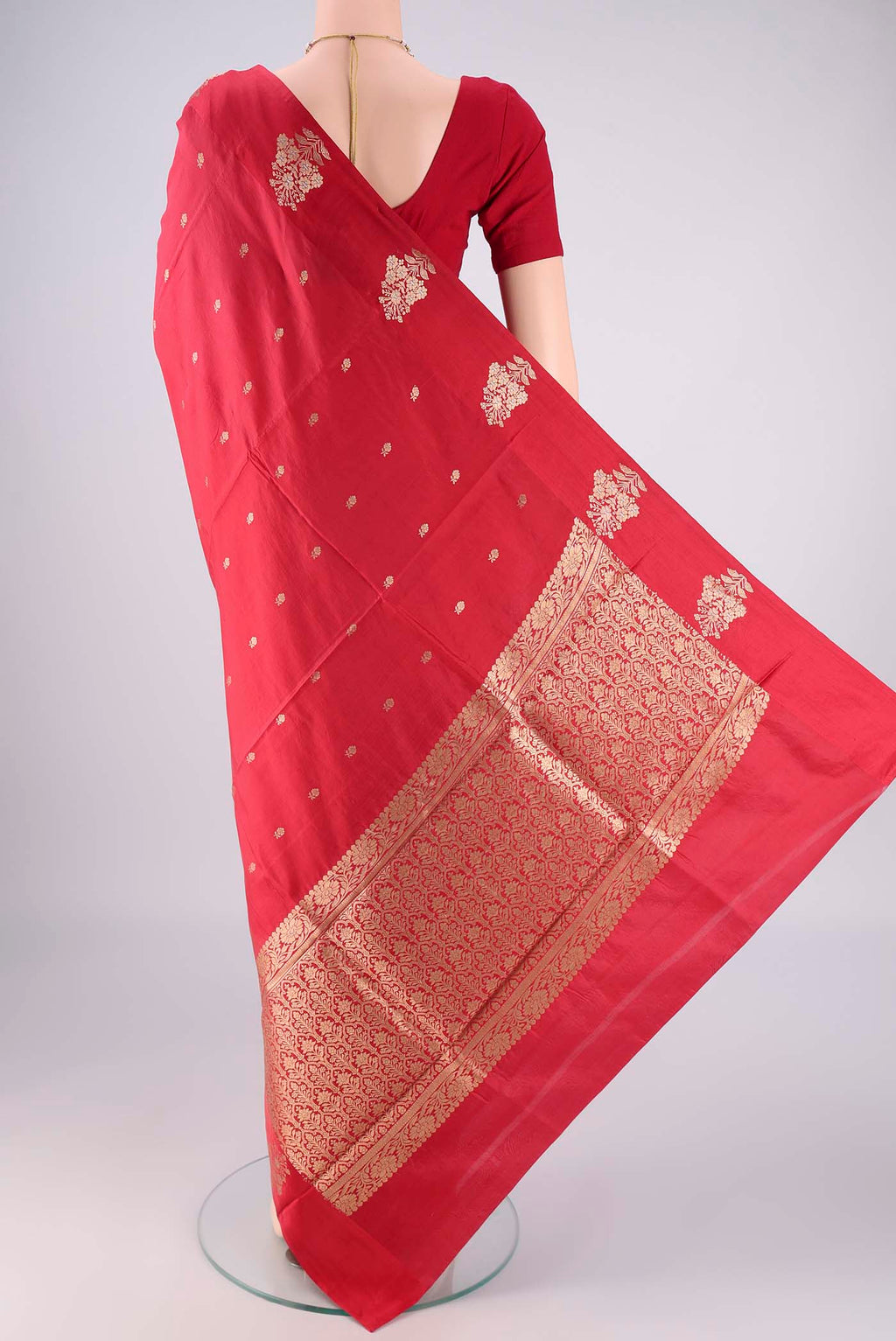 Flat view of Red Banarasi Katan Silk Saree with Zari Butta on the body and Plain Border. 