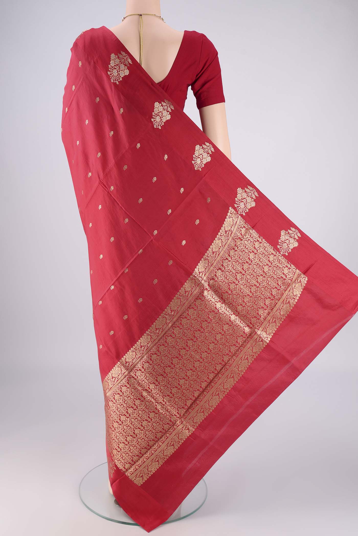 Flat view of Red Banarasi Katan Silk Saree with Zari Butta on the body and Plain Border. 