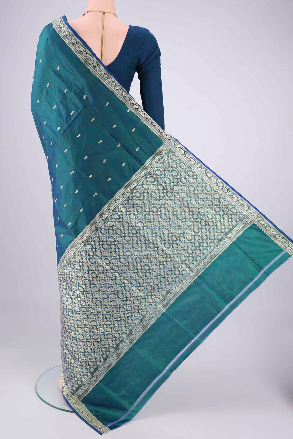 Flat view of Peacock Blue Dual Tone Banarasi Silk Saree with Thread Butta on the body and Thread Border. 
