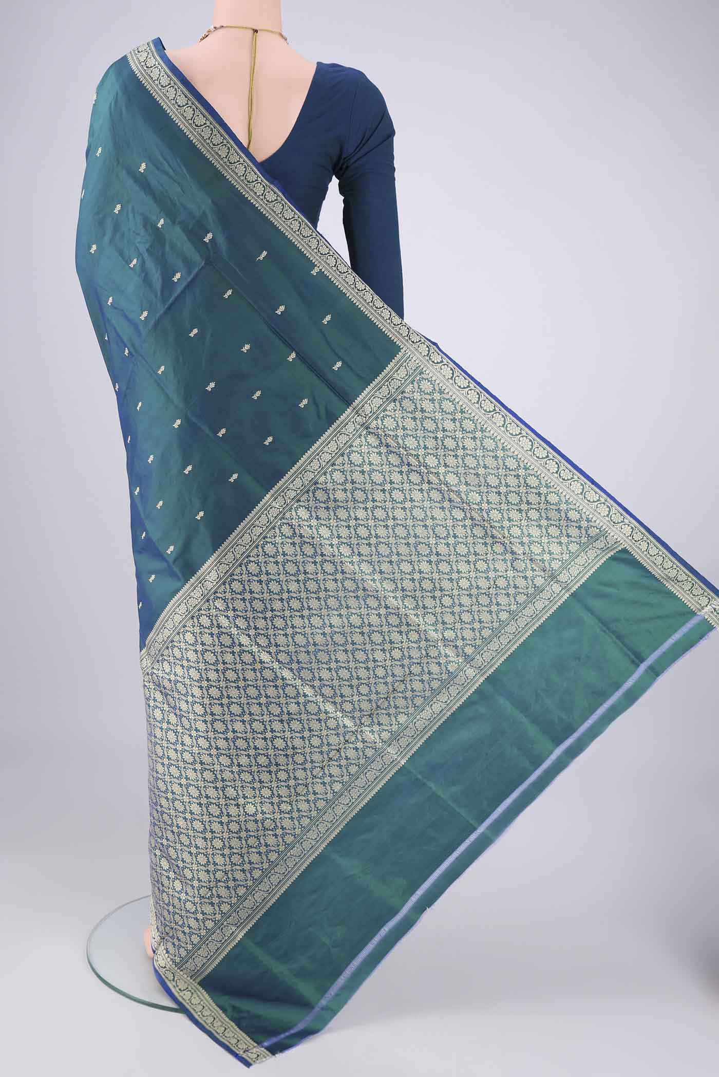 Flat view of Peacock Blue Dual Tone Banarasi Silk Saree with Thread Butta on the body and Thread Border. 