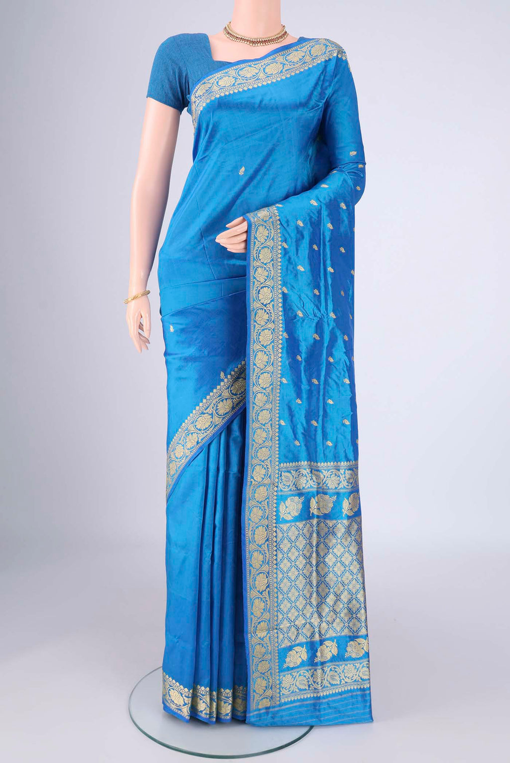 Electric Blue Banarasi Silk Saree with Thread Butta on the body and Thread Border.  displayed on a mannequin