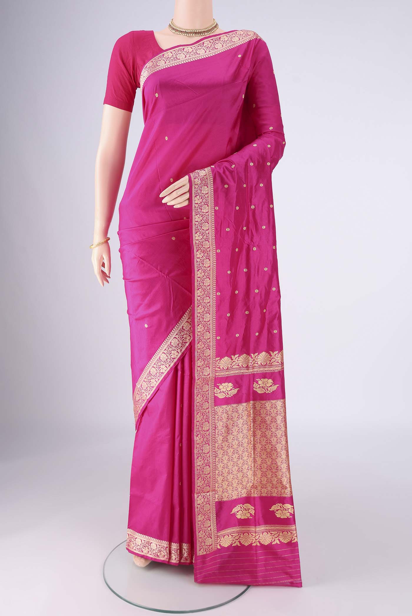 Rani Pink Banarasi Silk Saree with Thread Butta on the body and Thread Border.  displayed on a mannequin