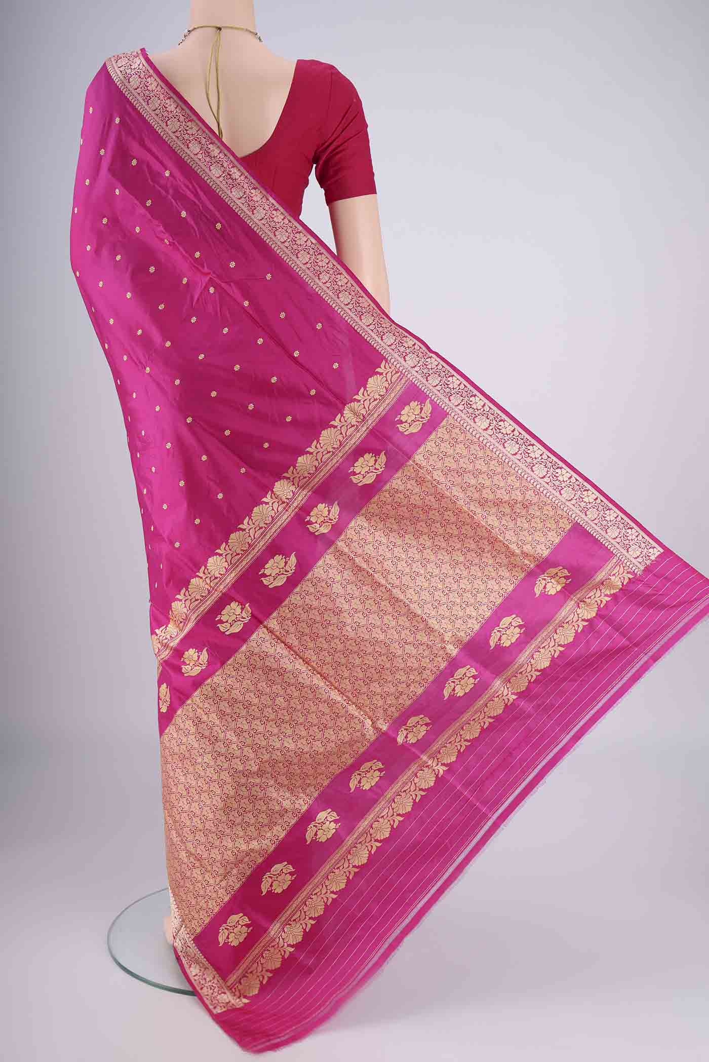 Flat view of Rani Pink Banarasi Silk Saree with Thread Butta on the body and Thread Border. 