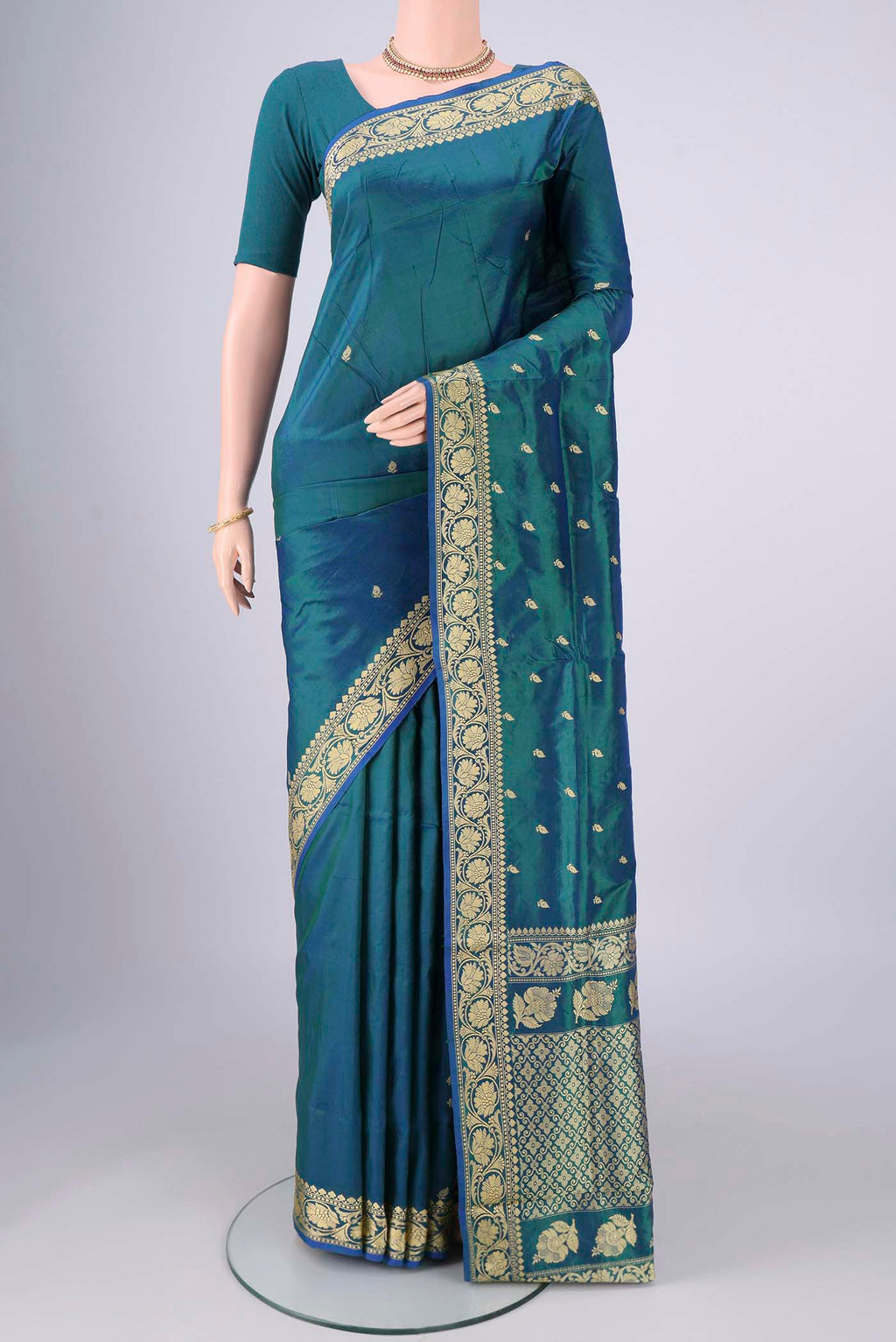 Peacock Blue Banarasi Silk Saree with Thread Butta on the body and Thread Border.  displayed on a mannequin