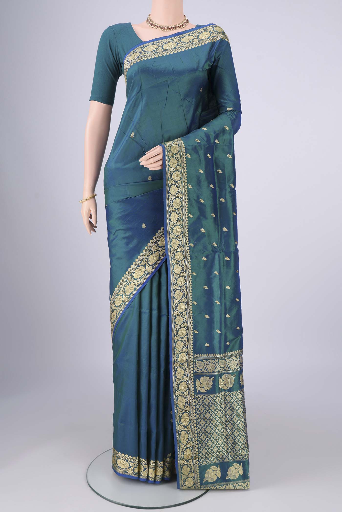 Peacock Blue Banarasi Silk Saree with Thread Butta on the body and Thread Border.  displayed on a mannequin