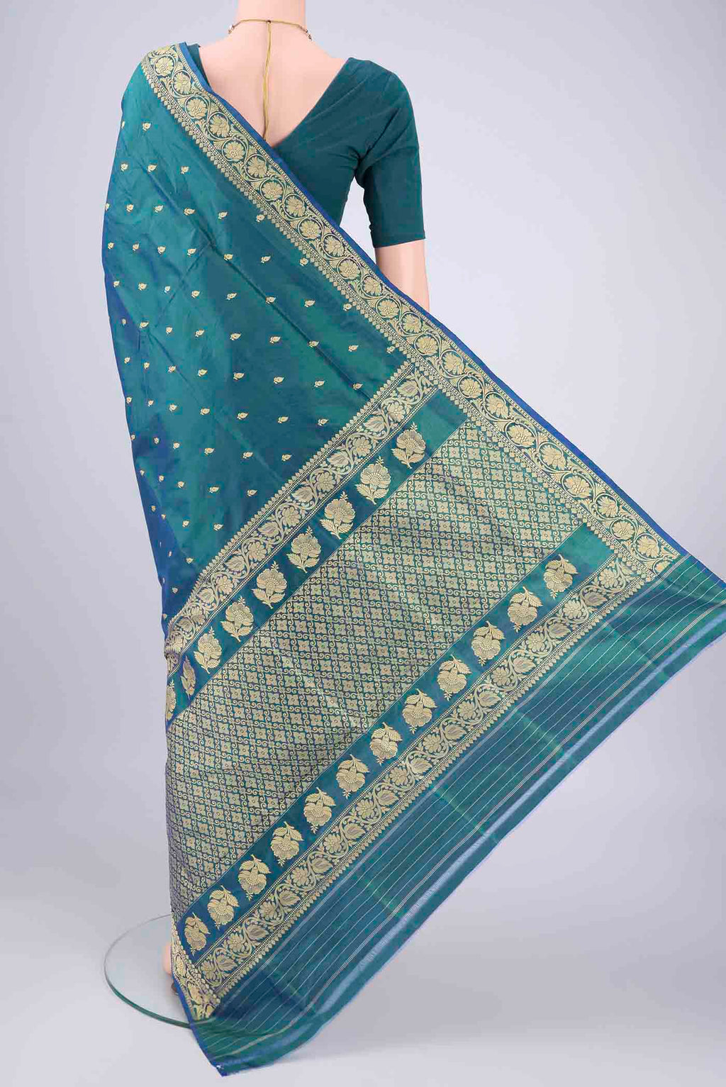 Flat view of Peacock Blue Banarasi Silk Saree with Thread Butta on the body and Thread Border. 