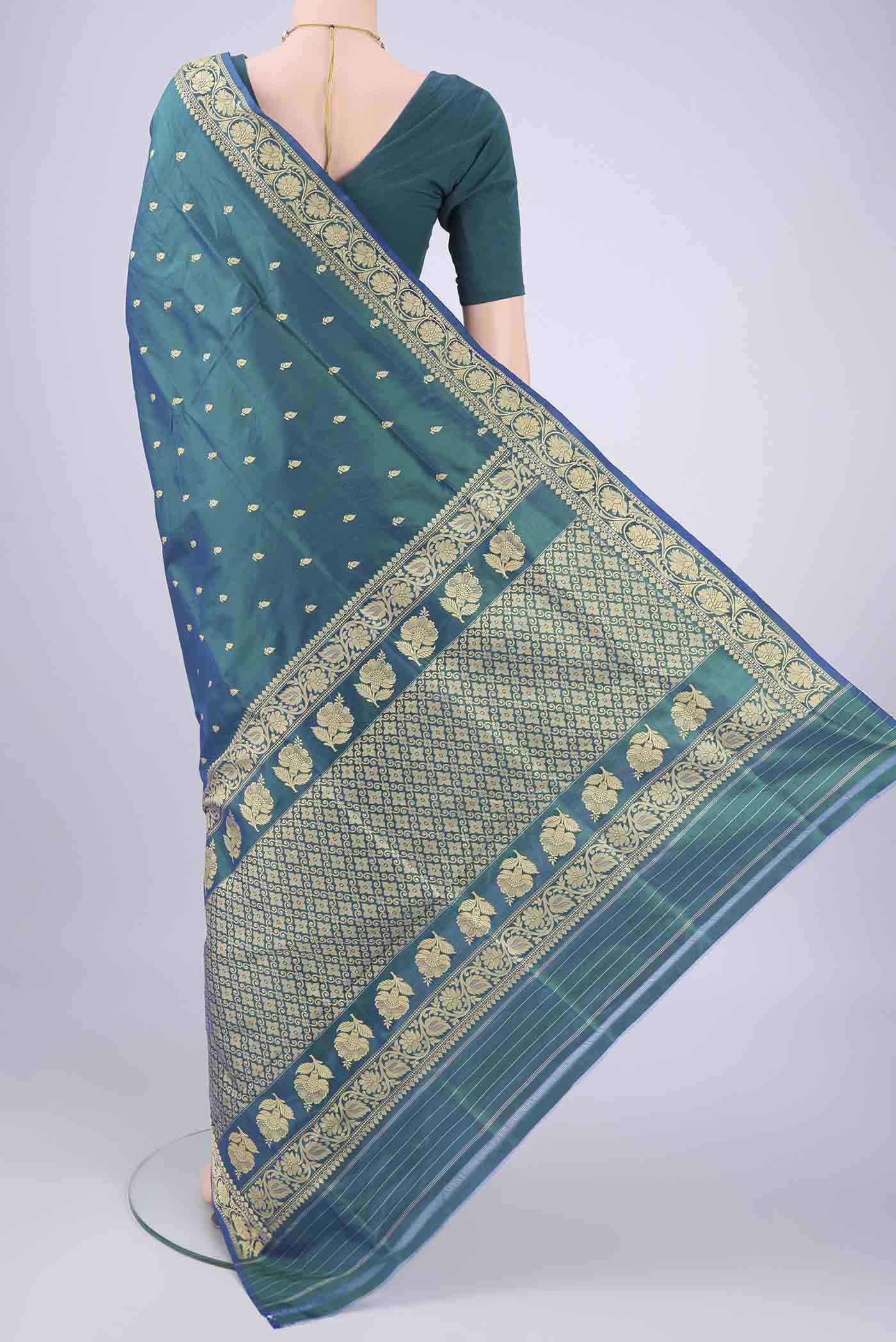 Flat view of Peacock Blue Banarasi Silk Saree with Thread Butta on the body and Thread Border. 