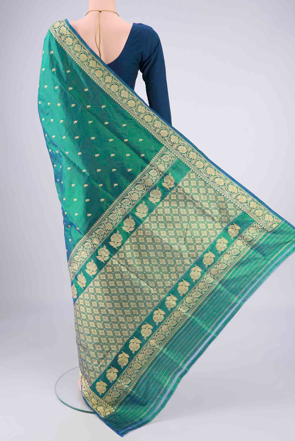 Flat view of Peacock Blue Dual Tone Banarasi Silk Saree with Thread Butta on the body and Thread Border. 