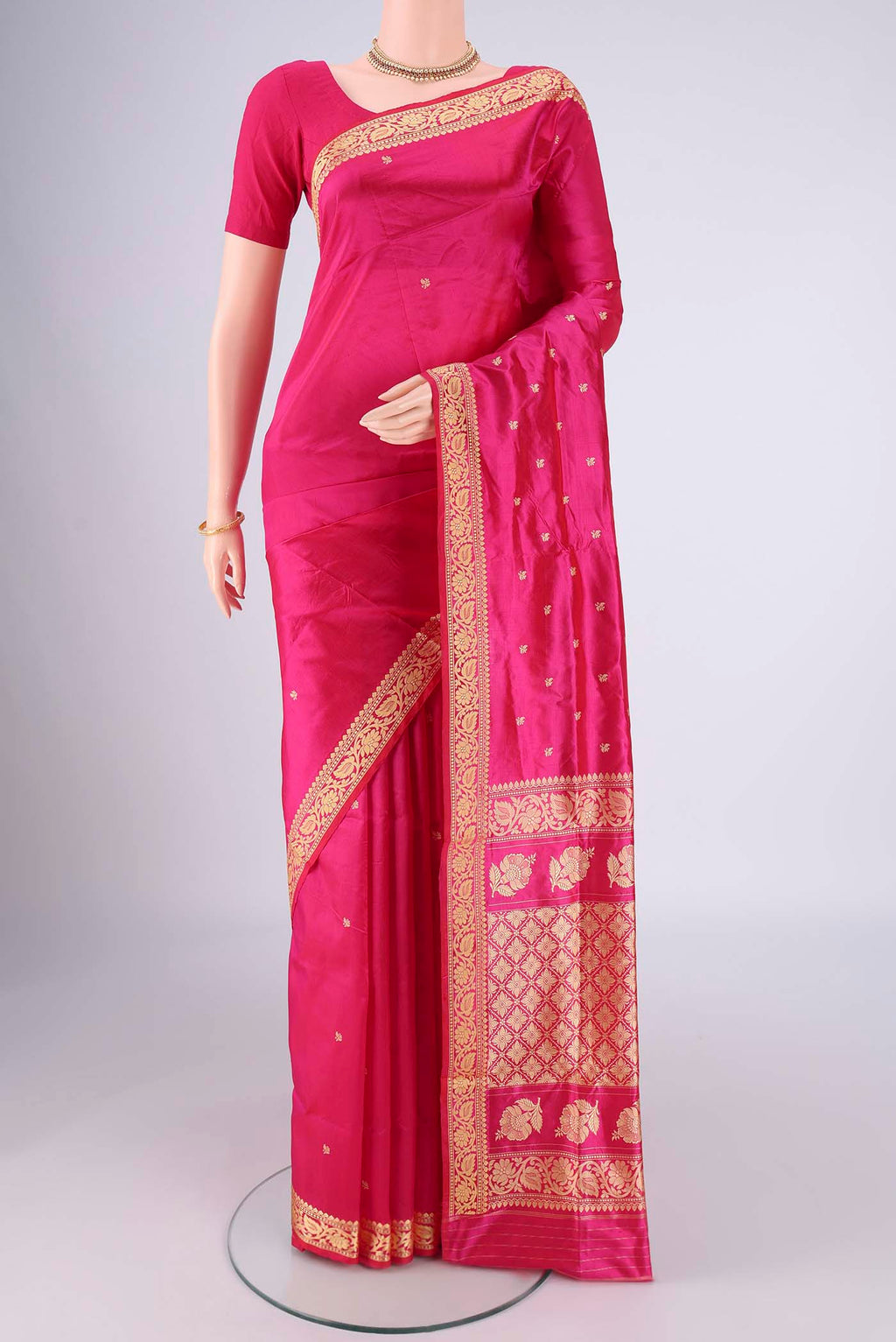 Rani Pink Banarasi Silk Saree with Thread Butta on the body and Thread Border.  displayed on a mannequin