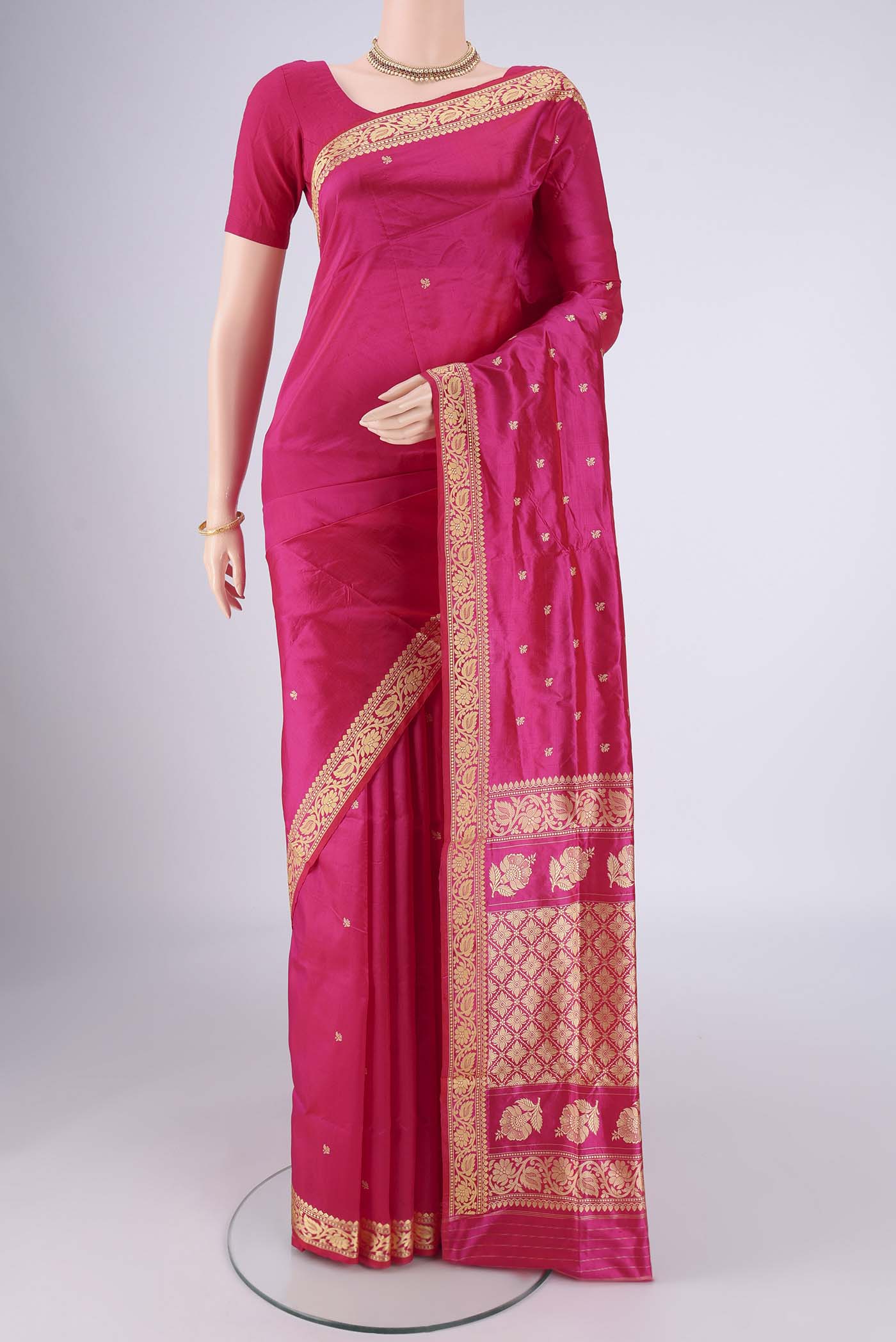 Rani Pink Banarasi Silk Saree with Thread Butta on the body and Thread Border.  displayed on a mannequin