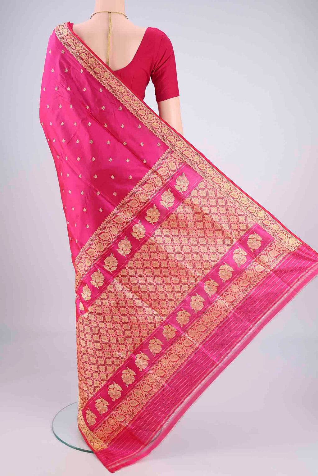 Flat view of Rani Pink Banarasi Silk Saree with Thread Butta on the body and Thread Border. 