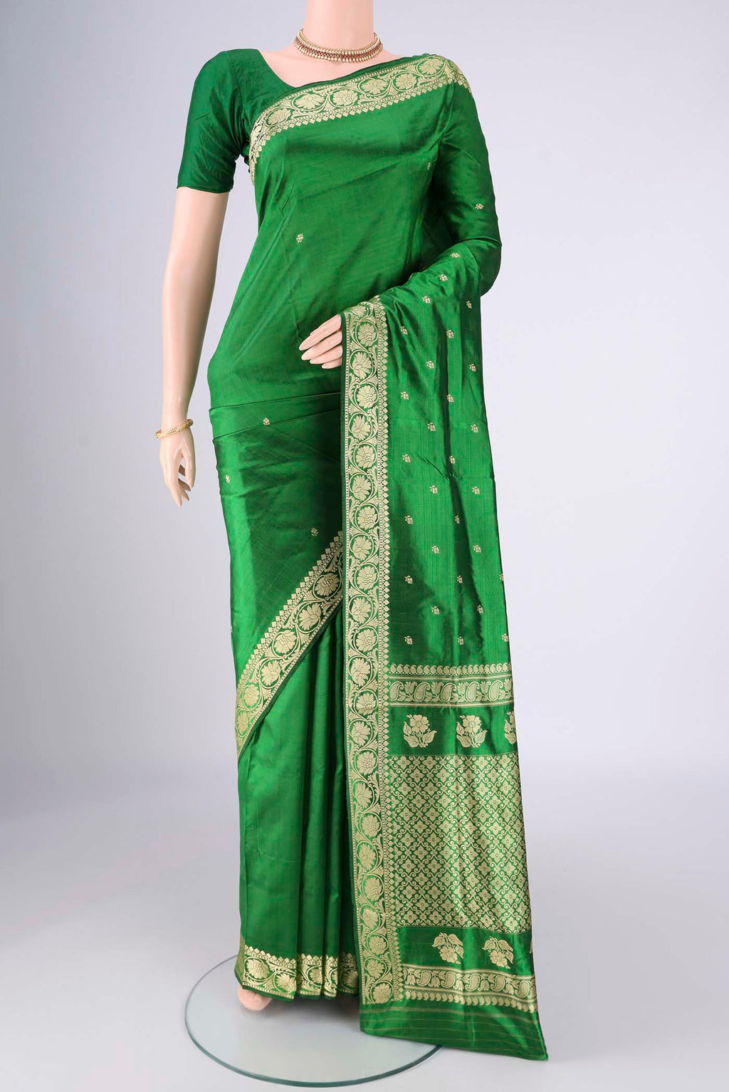 Green Banarasi Silk Saree with Thread Butta on the body and Thread Border.  displayed on a mannequin