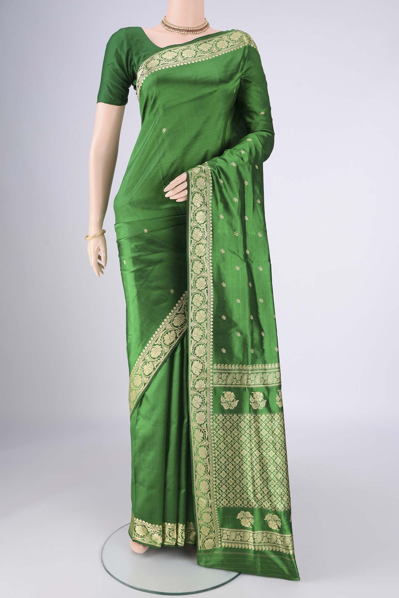 Green Banarasi Silk Saree with Thread Butta on the body and Thread Border.  displayed on a mannequin