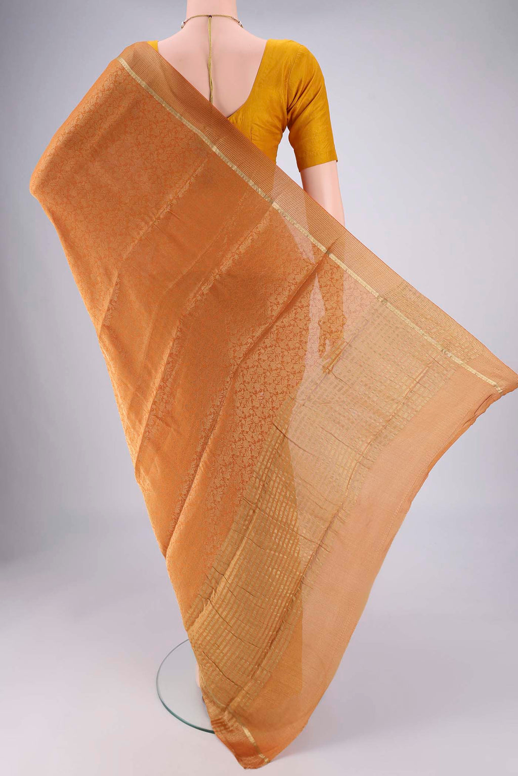 Flat view of Mustard Mysore Crepe Saree with Zari Brocade on the body and Zari Border. 