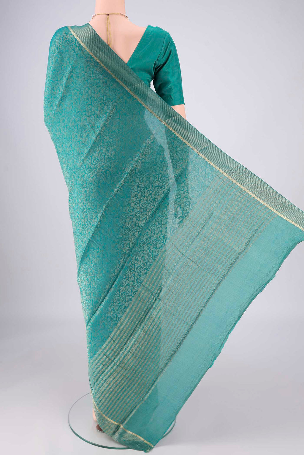 Flat view of Turquoise Mysore Crepe Saree with Zari Butta on the body and Zari Border. 