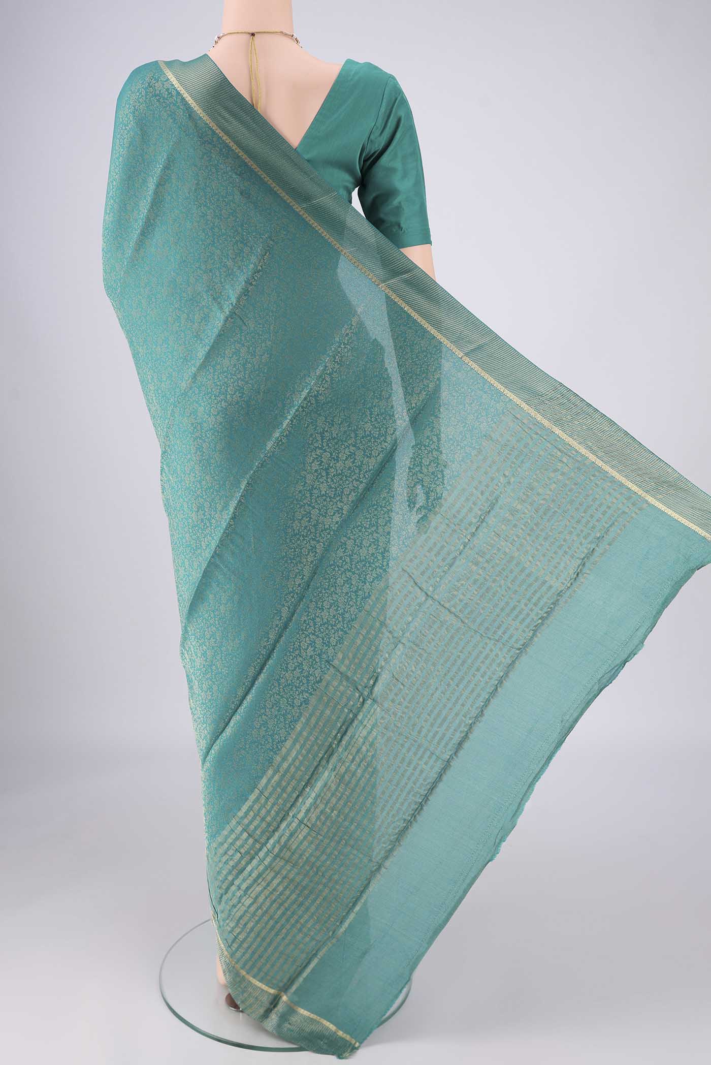 Flat view of Turquoise Mysore Crepe Saree with Zari Butta on the body and Zari Border. 