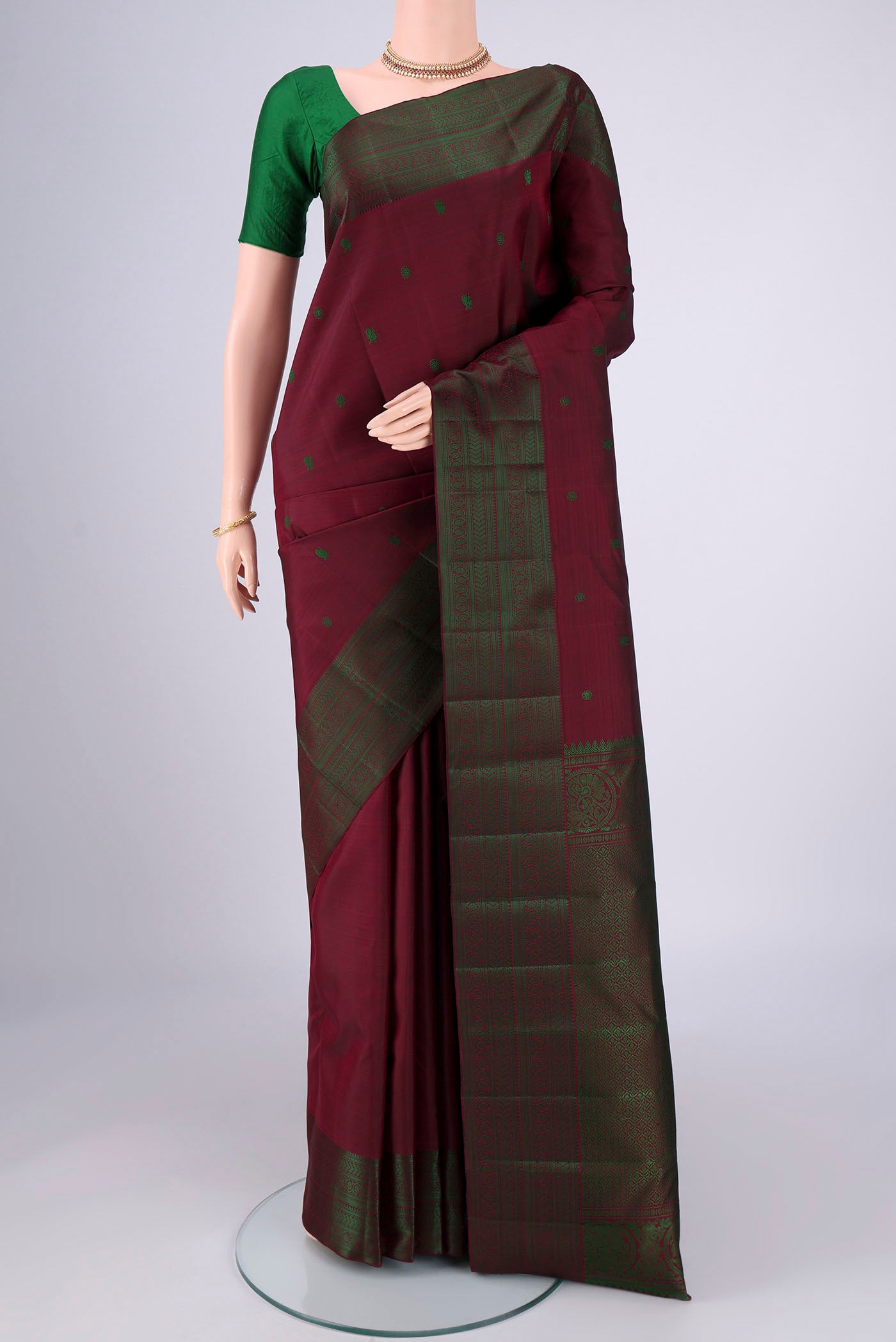 Coffee Brown Kanchipuram Silk Saree with Thread Butta on the body and Thread Border.  displayed on a mannequin