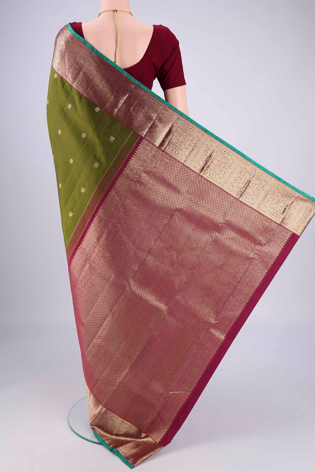 Flat view of Pure Silk Pure Zari Mehandi Green Kanchipuram Saree with Zari Butta on the body and Zari Border. 