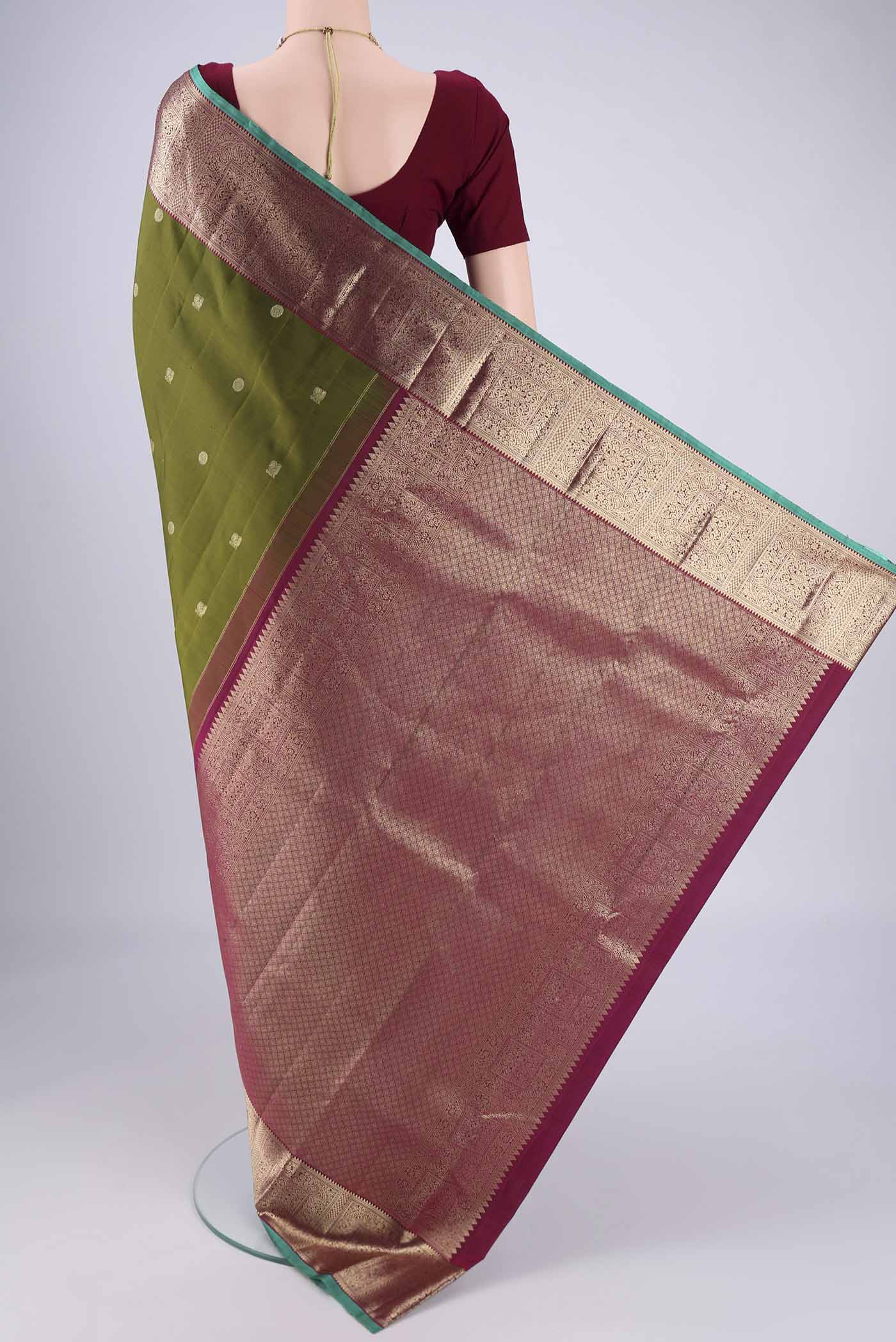Flat view of Pure Silk Pure Zari Mehandi Green Kanchipuram Saree with Zari Butta on the body and Zari Border. 