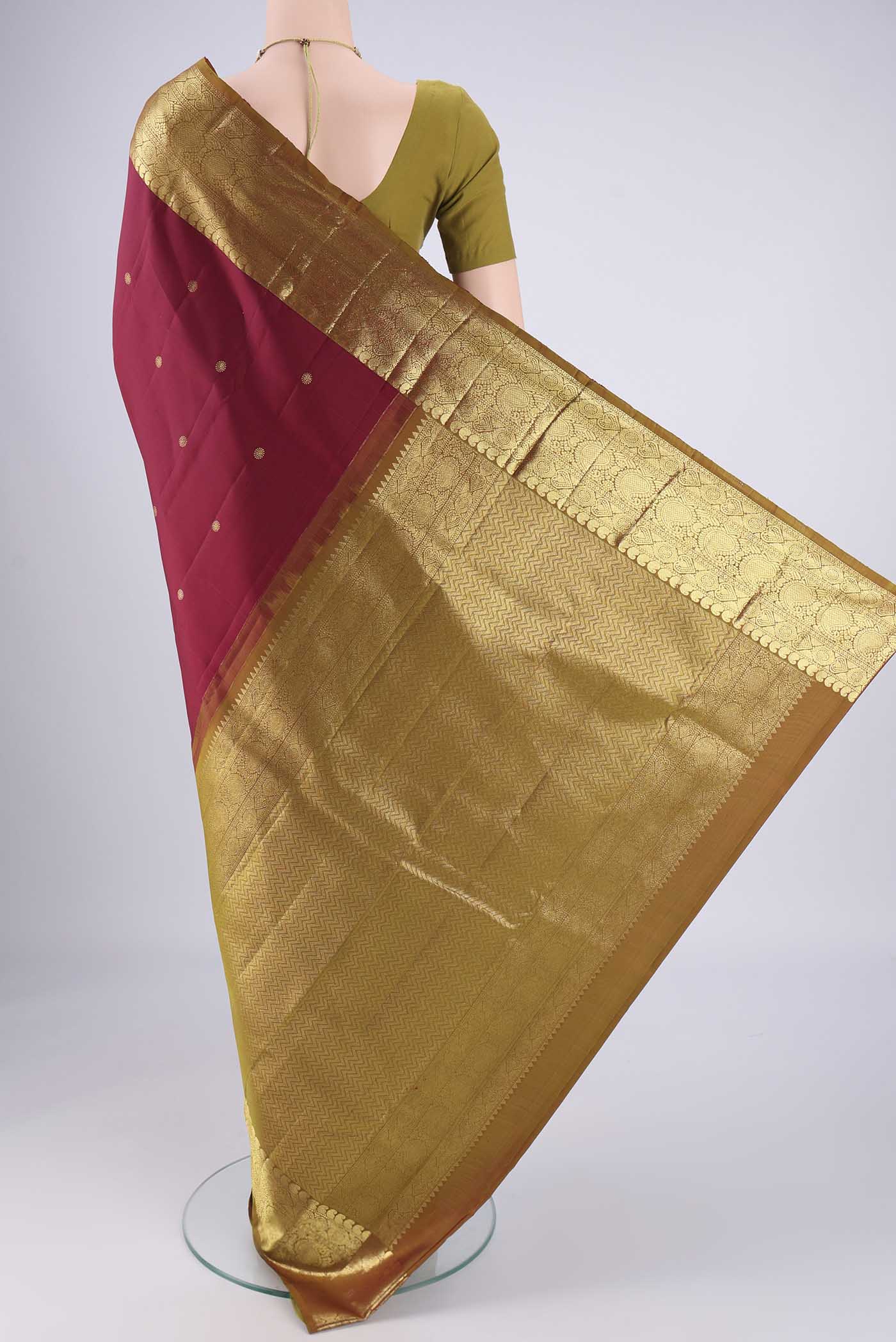 Flat view of Pure Silk Pure Zari Maroon Kanchipuram Saree with Zari Butta on the body and Zari Border. 