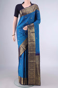Pure Silk Blue Kanchipuram Saree with Zari Butta on the body and Zari Border.  displayed on a mannequin