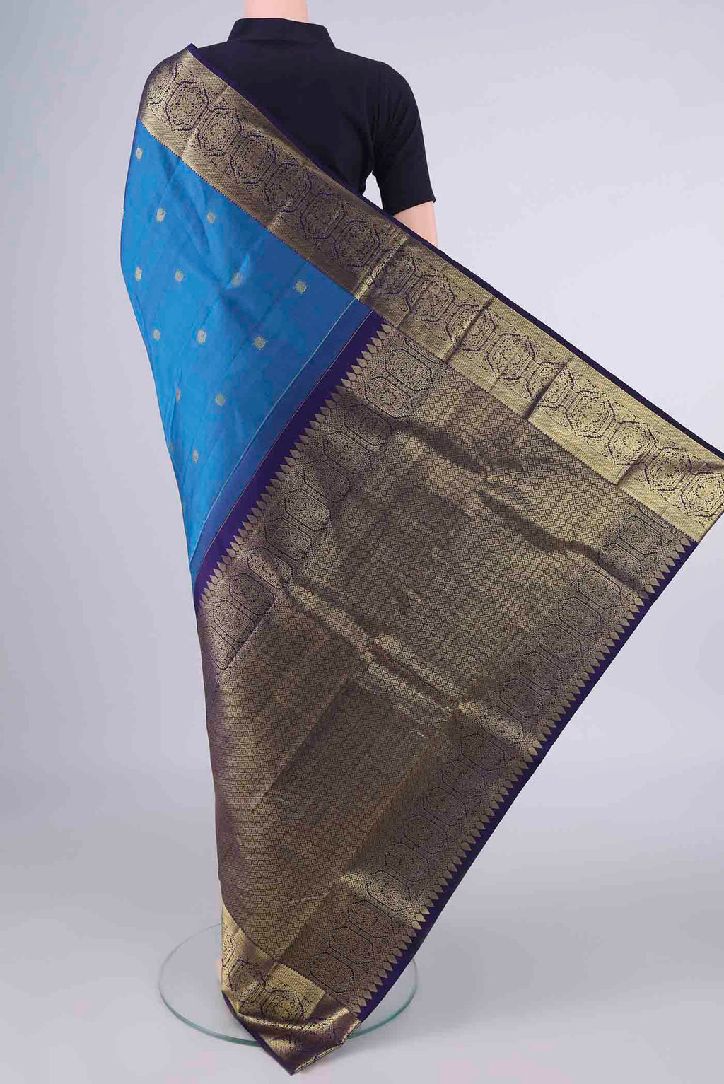 Flat view of Pure Silk Blue Kanchipuram Saree with Zari Butta on the body and Zari Border. 