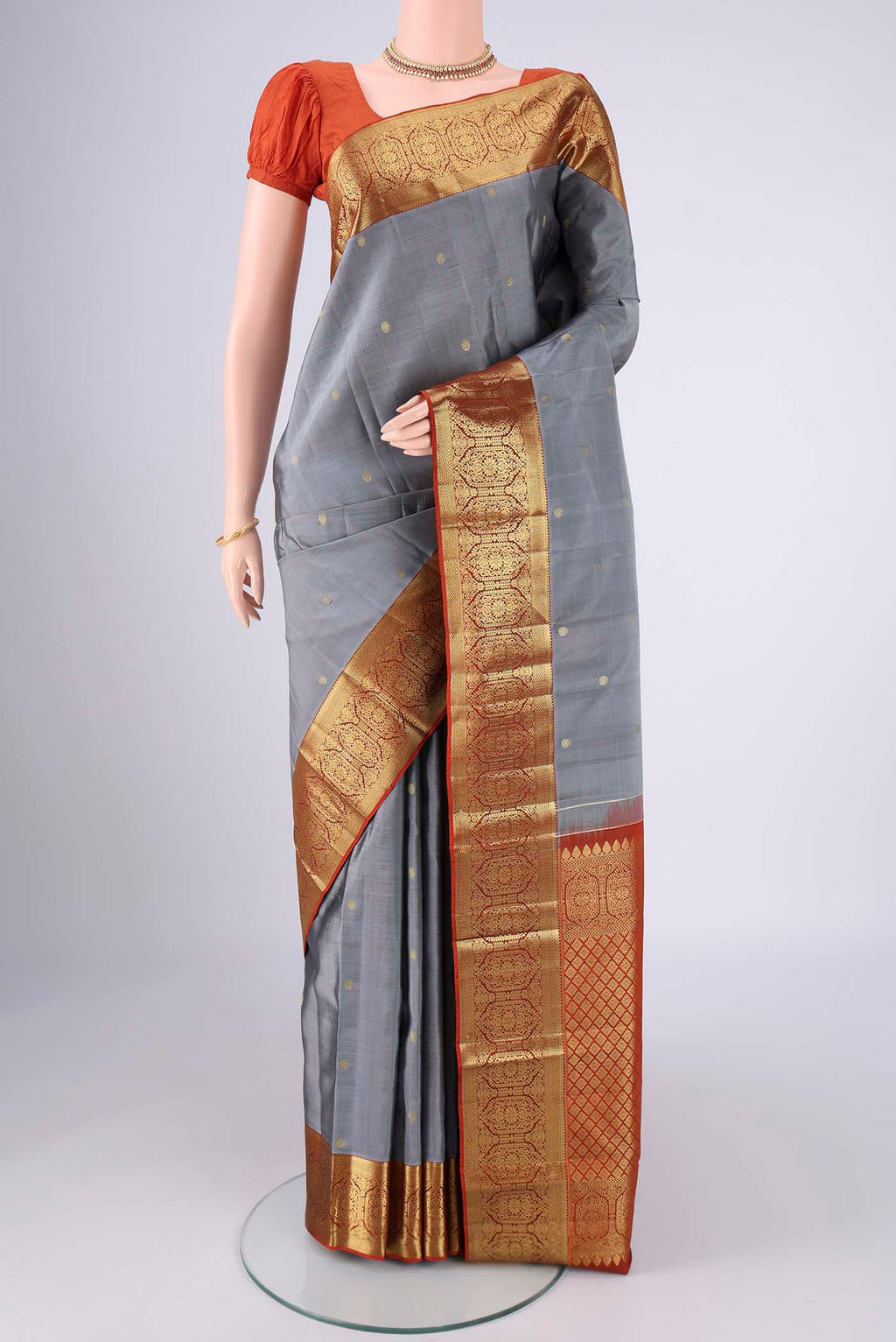 Grey Kanchipuram Silk Saree with Zari Butta on the body and Zari Border.  displayed on a mannequin