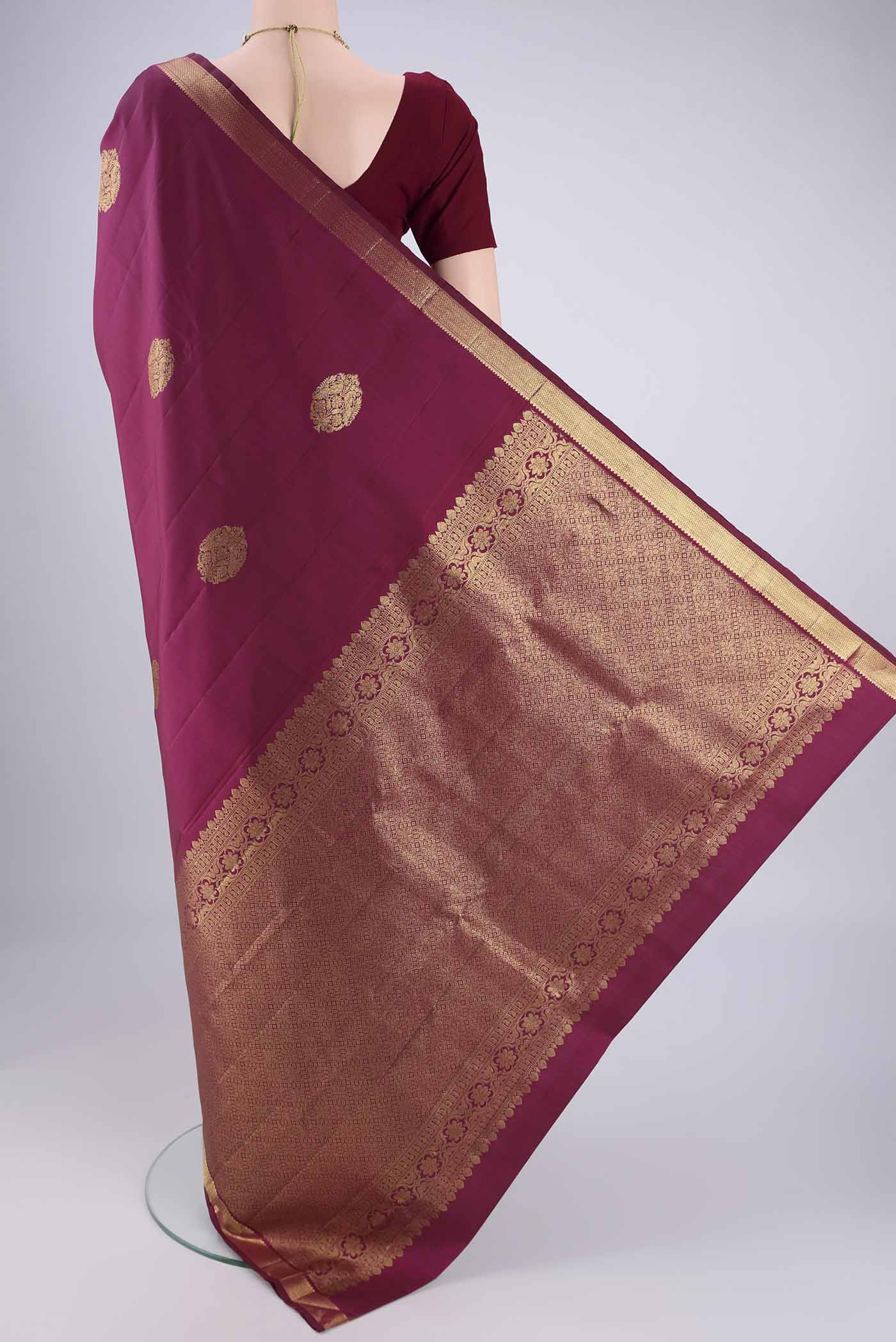Flat view of Pure Silk Pure Zari Magenta Kanchipuram Saree with Zari Butta on the body and Zari Border. 