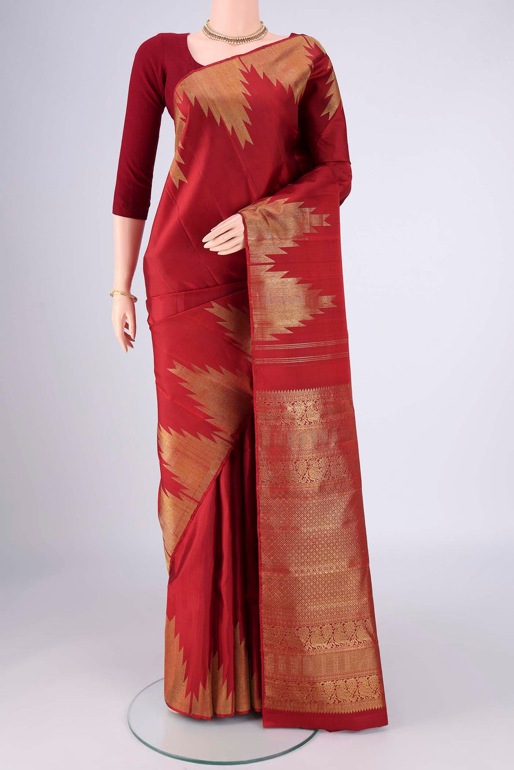 Red Kanchipuram Silk Saree with Plain Body and Temple Border.  displayed on a mannequin
