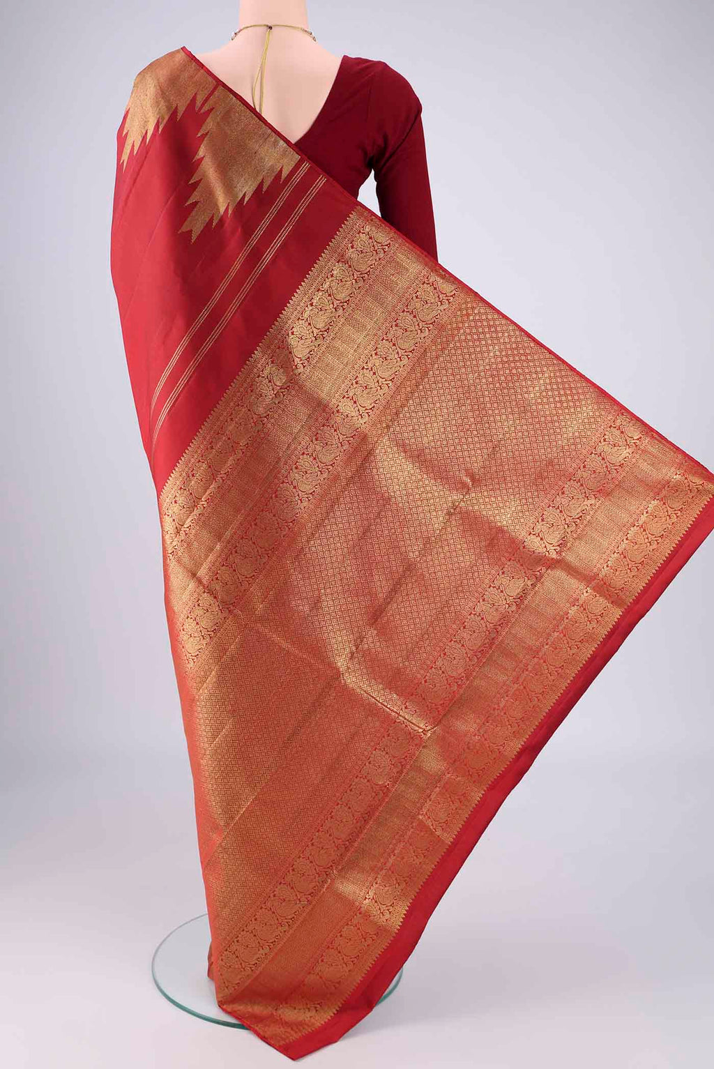 Flat view of Red Kanchipuram Silk Saree with Plain Body and Temple Border. 