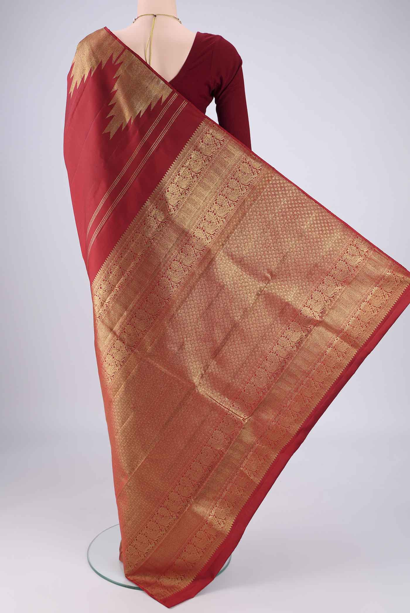 Flat view of Red Kanchipuram Silk Saree with Plain Body and Temple Border. 