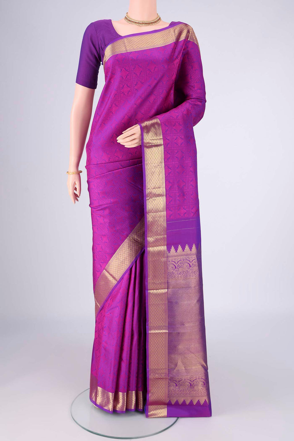 Purple Kanjivaram Saree with Jacquard design on the body and Zari Border.  displayed on a mannequin