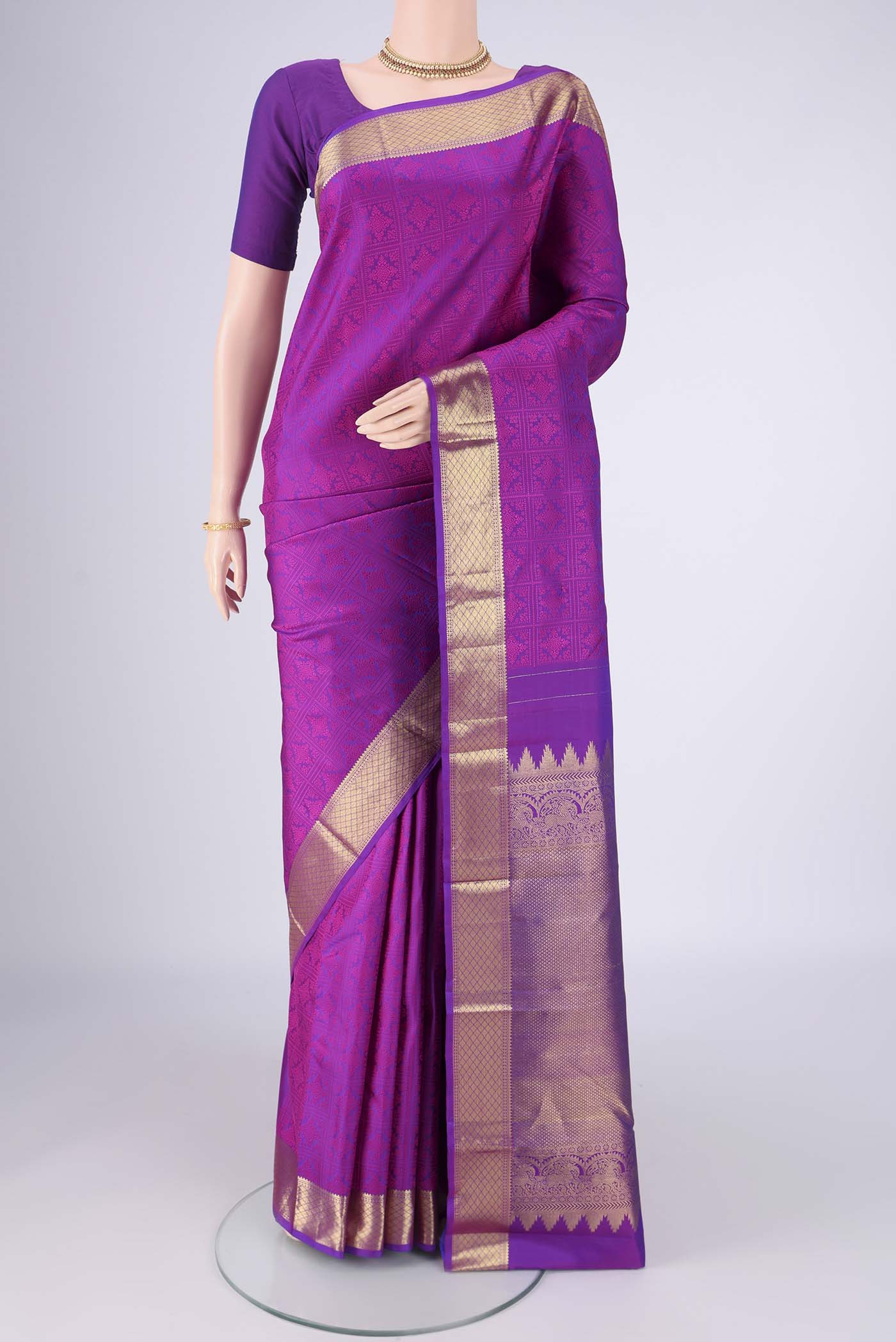 Purple Kanjivaram Saree with Jacquard design on the body and Zari Border.  displayed on a mannequin