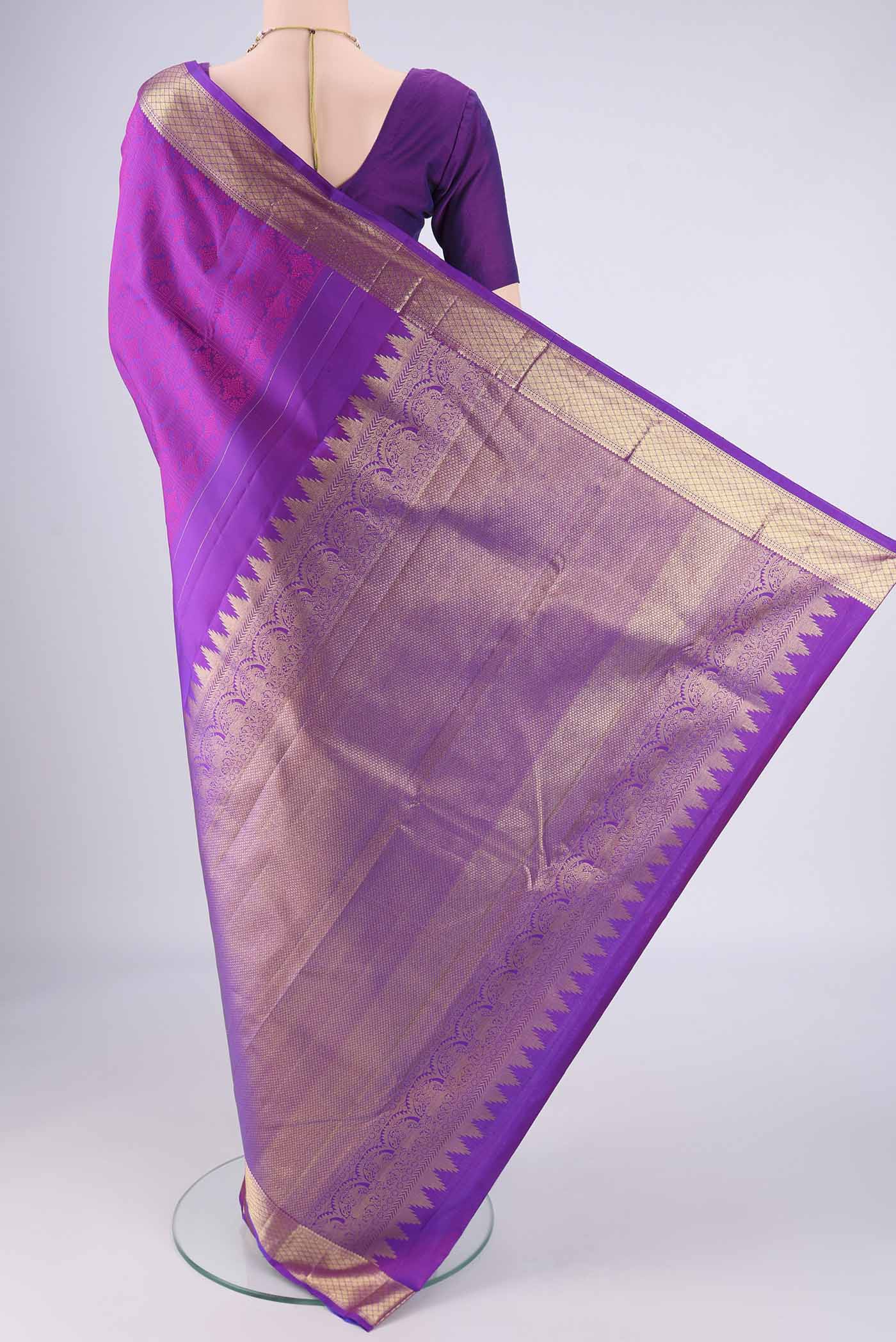 Flat view of Purple Kanjivaram Saree with Jacquard design on the body and Zari Border. 