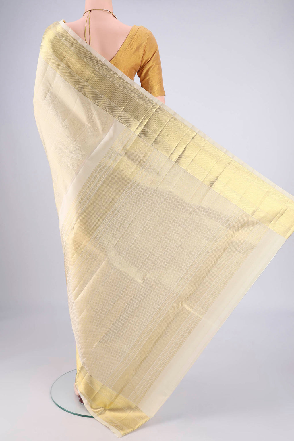 Flat view of Off White Kanjivaram Silk Saree with Jacquard design on the body and Zari Border. 