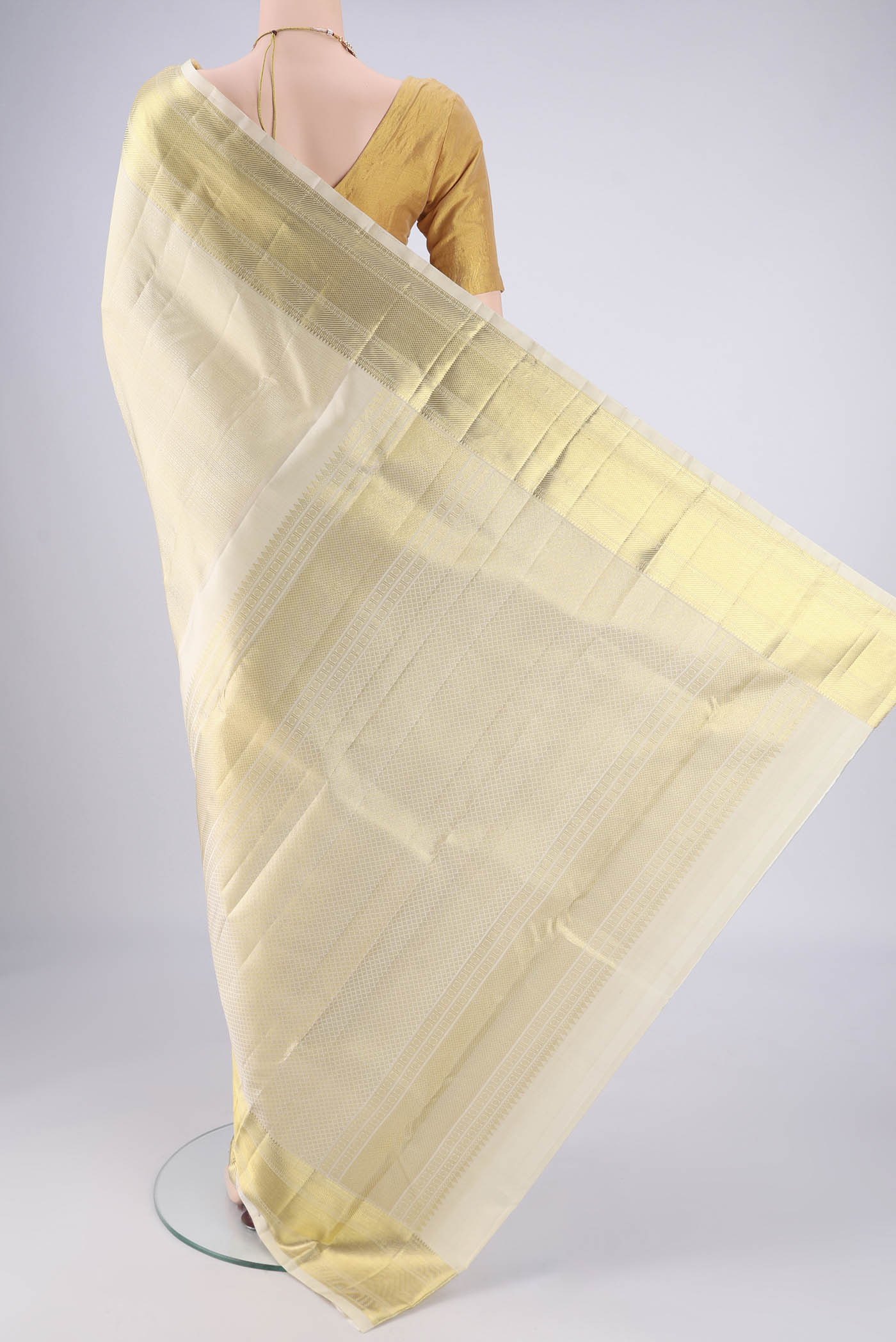 Flat view of Off White Kanjivaram Silk Saree with Jacquard design on the body and Zari Border. 