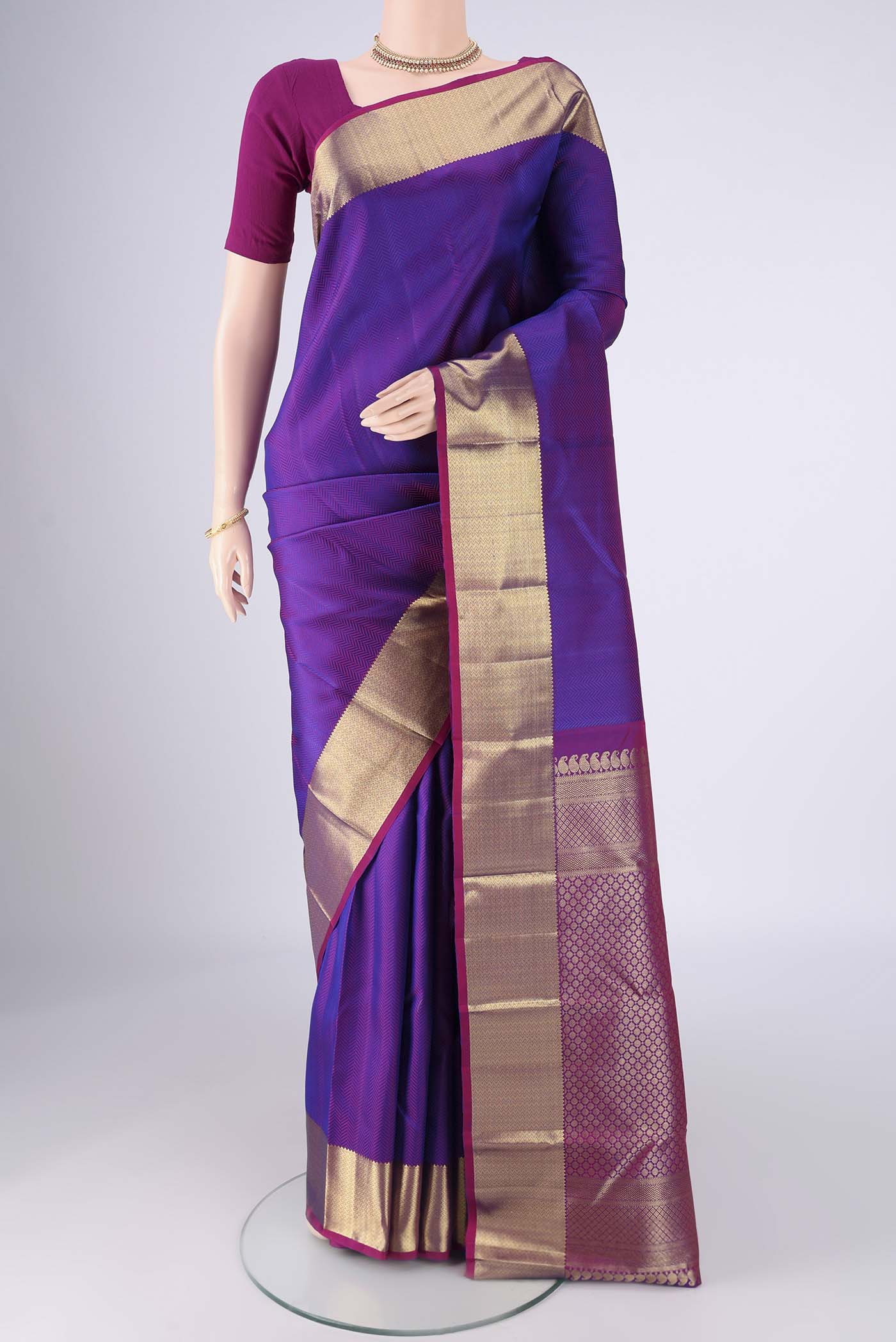 Purple Kanjivaram Silk Saree with Jacquard design on the body and Zari Border.  displayed on a mannequin